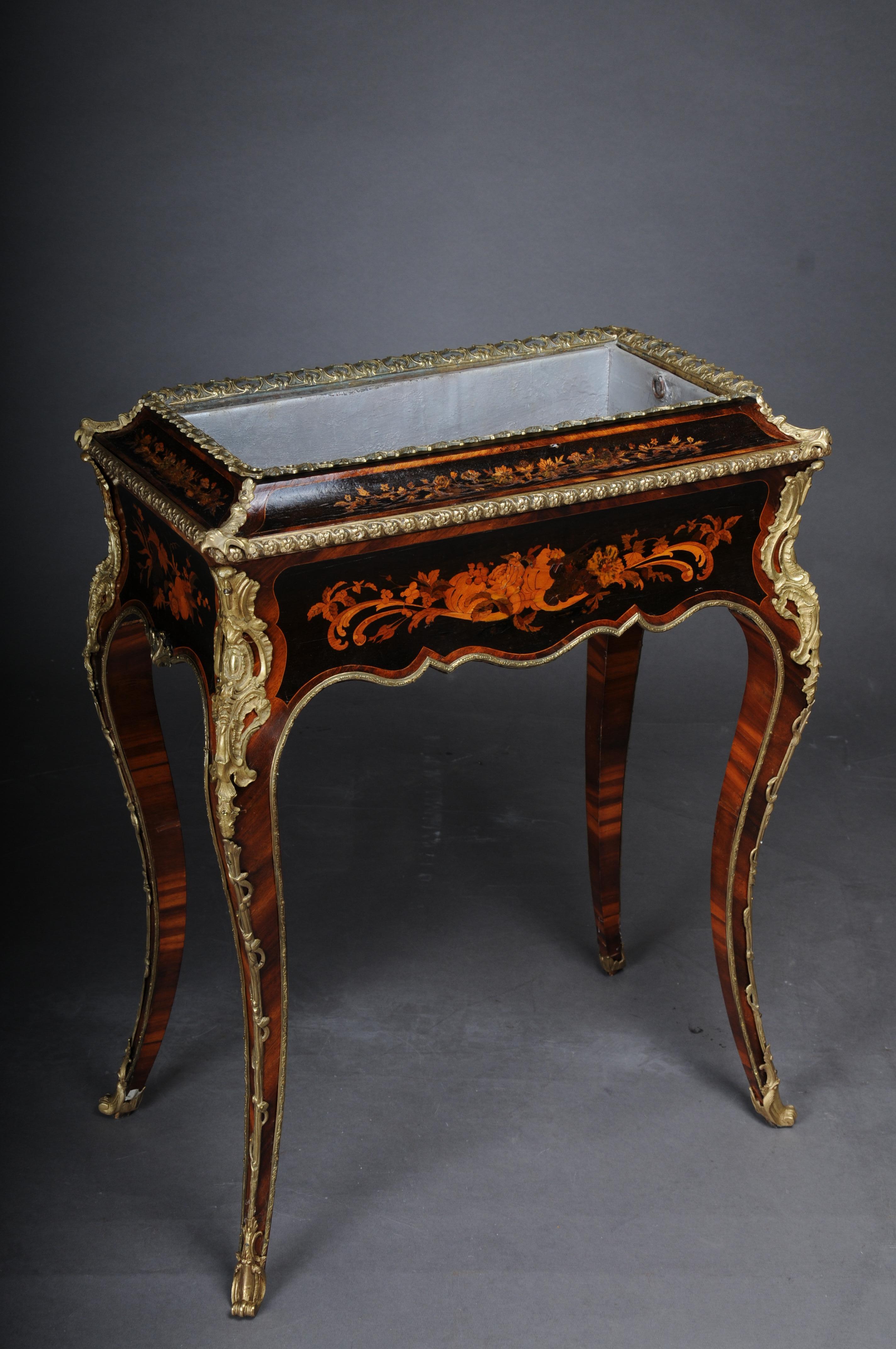 Antique rare Jardiniere side table Napoleon III

Solid wood with the finest tulip veneer and inlaid marquetry. Partially ebonized. Multipassig curly frame box. Side table jardiniere completely framed with brass bronze. Inlaid box for flowers.
High