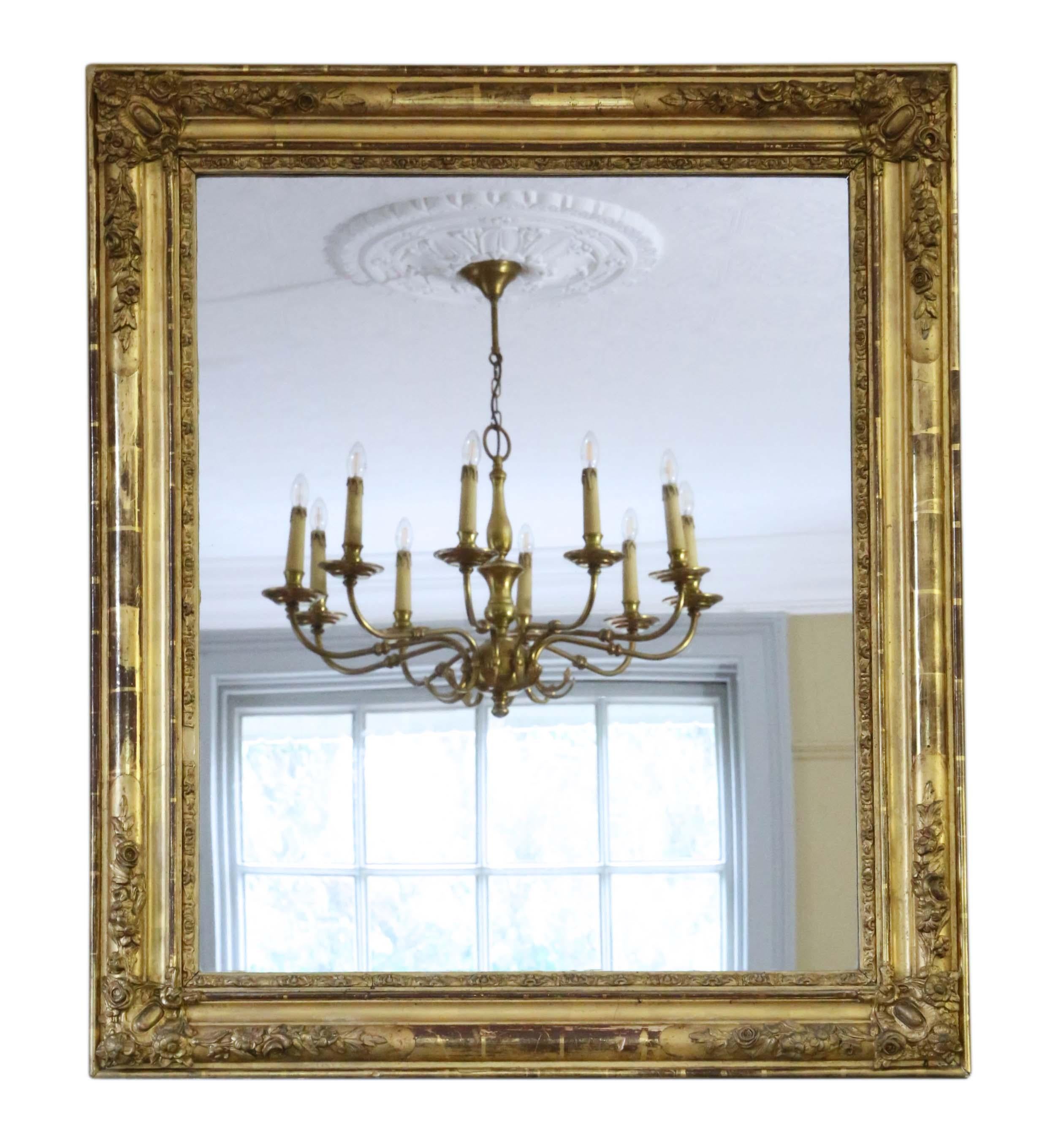 Antique rare large quality 19th century gilt overmantle or wall mirror. The mirror has its original glass and back. The frame has its beautiful original gilt finish with minor losses and touching up here and there.

An impressive find, that would