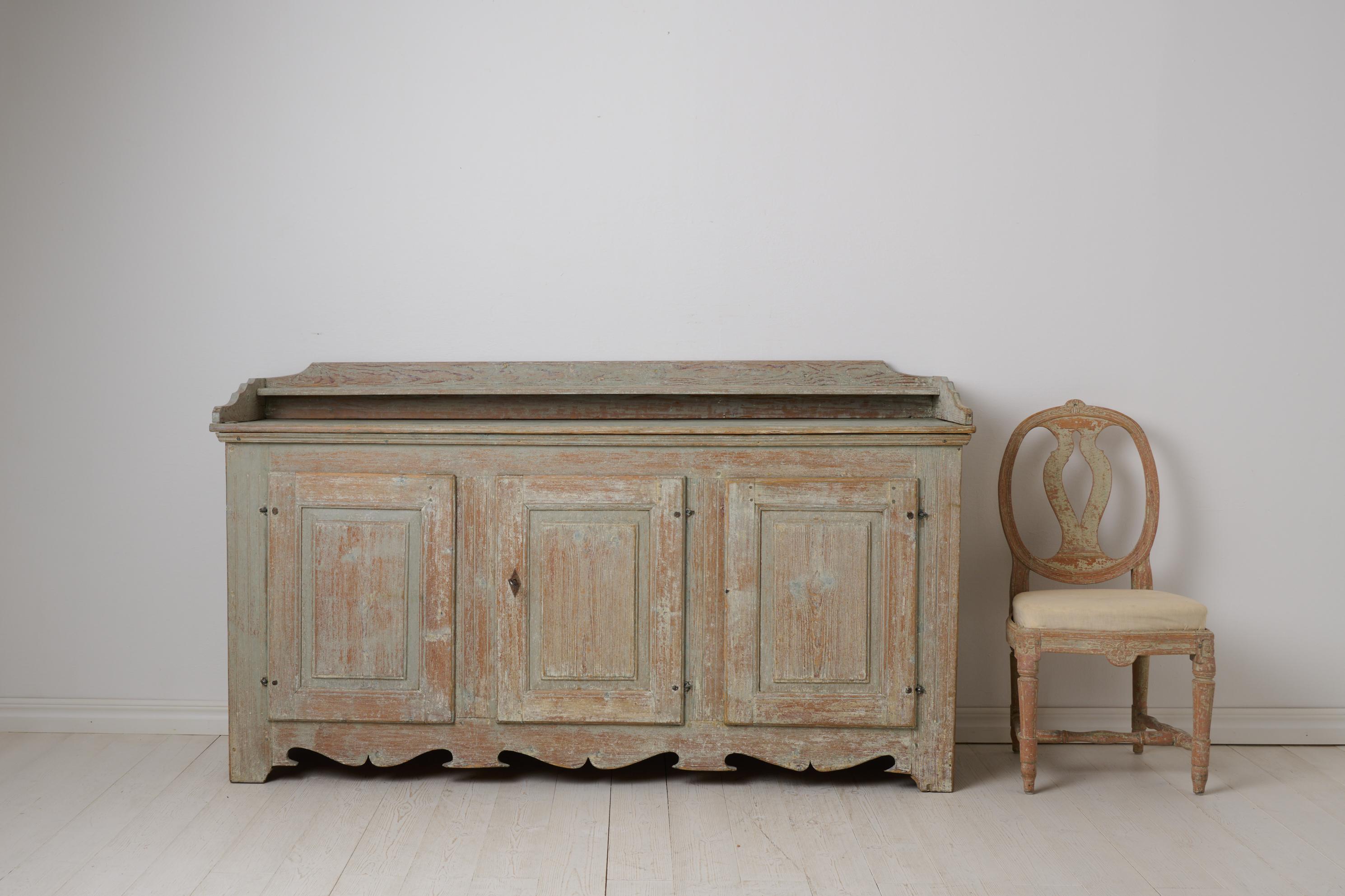 Wide Swedish antique sideboard. This sideboard is a country house furniture from the gustavian period made in northern Sweden around 1790. The proportions and craftsmanship makes it very rare, the sideboard is unusually low and wide, measuring 90 cm