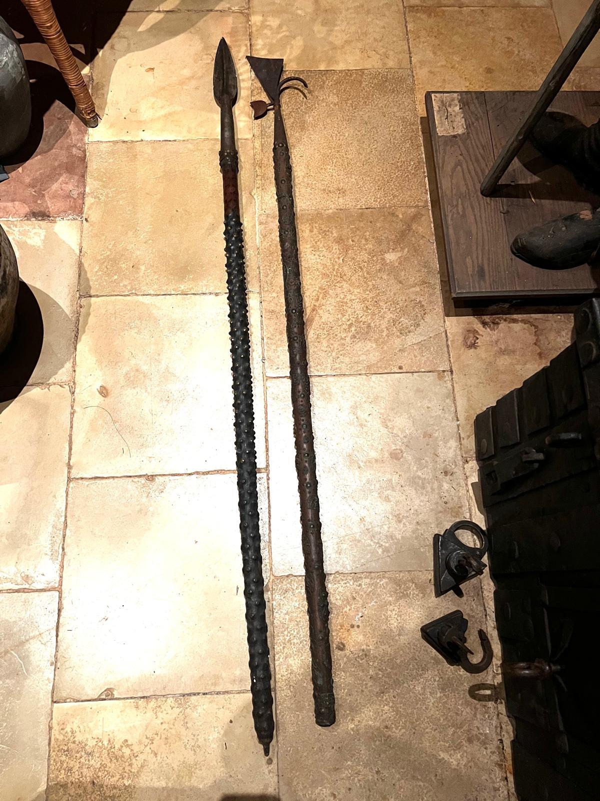 An extraordinary pair of medieval pole arms from the 15th-16th century, originating in the Habsburg Empire (Austria).
These rare weapons- comprising a long iron spear and a glaive- were designed for infantry combat and close encounters against both