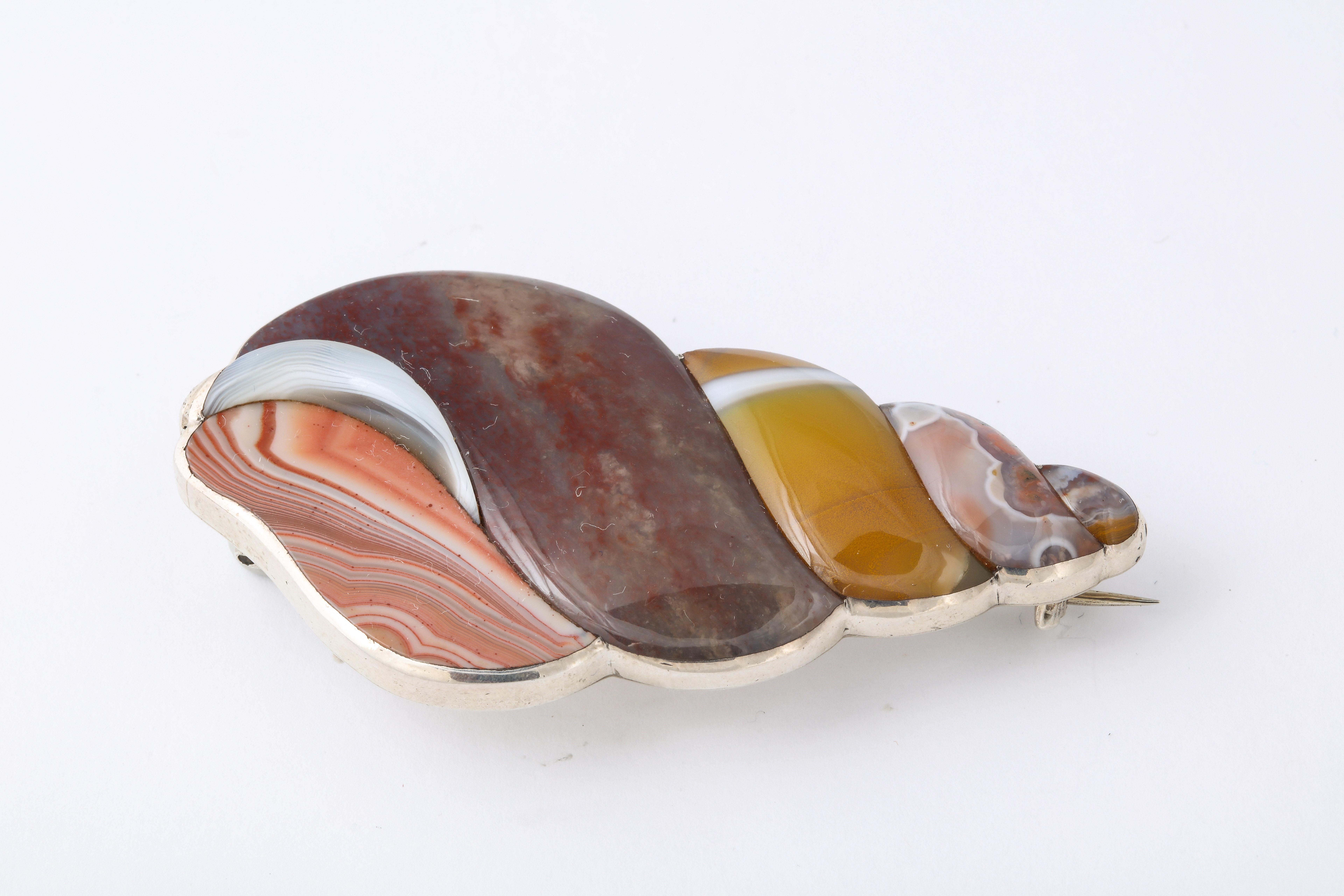 It is hard for a layman to imagine cutting and smoothing natural agate into swirling, shining shapes of beautiful color and patterns as you see in this Agate Sterling Tulip Shell brooch from Scotland. To accomplish this art takes a master jeweler