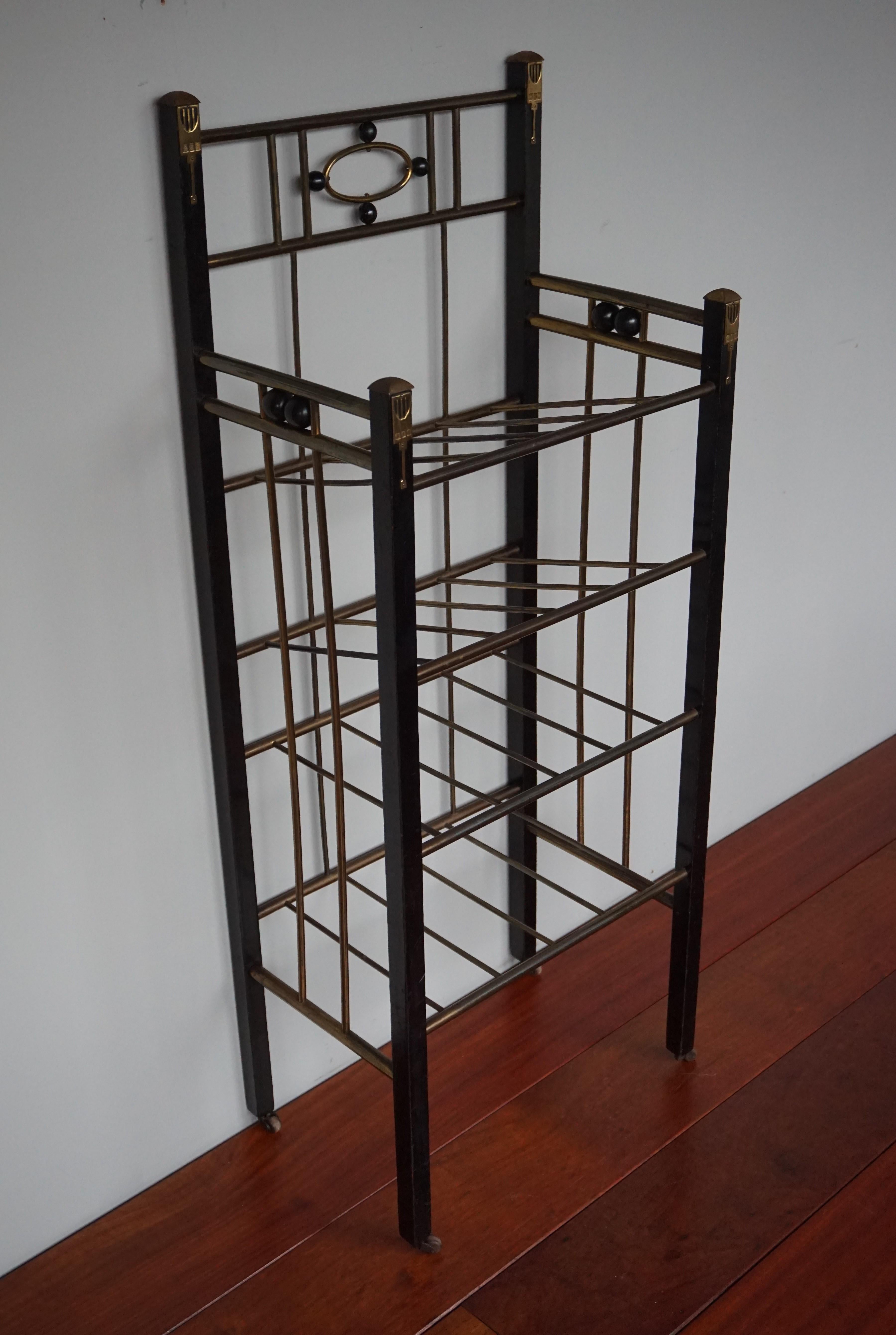 Stunning and practical ebonized stand with style elements in the manner of Josef Hoffmann.

This very stylish and all handcrafted modernist rack would have been made for the very well-to-do, circa turn of the century. The wooden legs of this rare