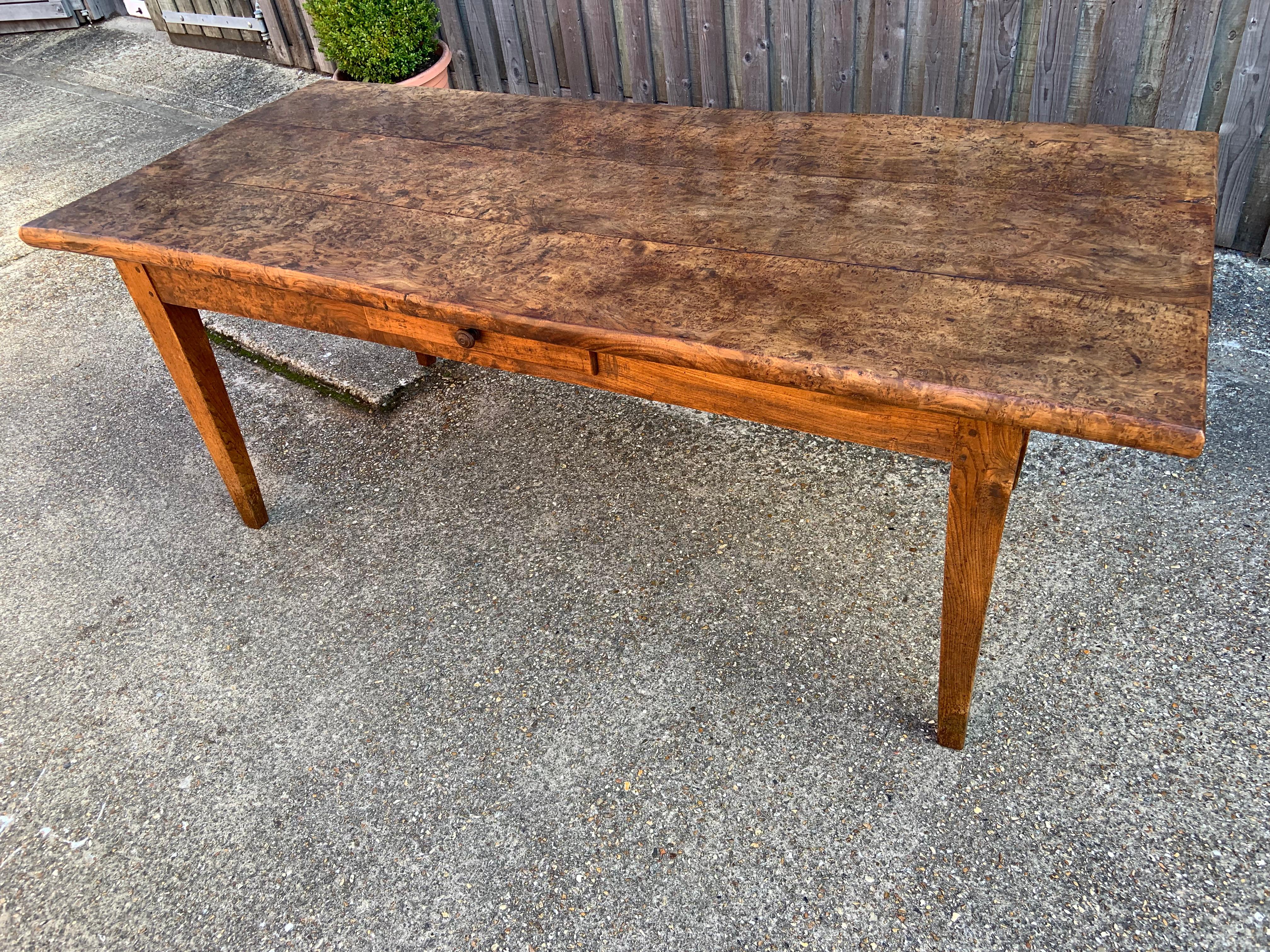 Antique rare wide burr elm thick top farmhouse table. The table has a beautiful burr elm three plank top with burr elm thick rails and elm legs. The top is 1.5 