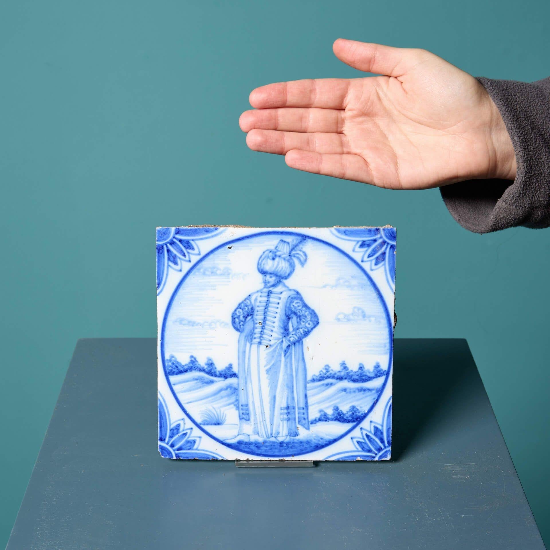An antique Delft tile of a figure in Turkish dress, circa 1870, made by Ravesteijn of Utrecht, after the original drawing by Nicolas De Nicolay dating to circa 1551.

This striking tile has been in use for over 150 years and as such has a