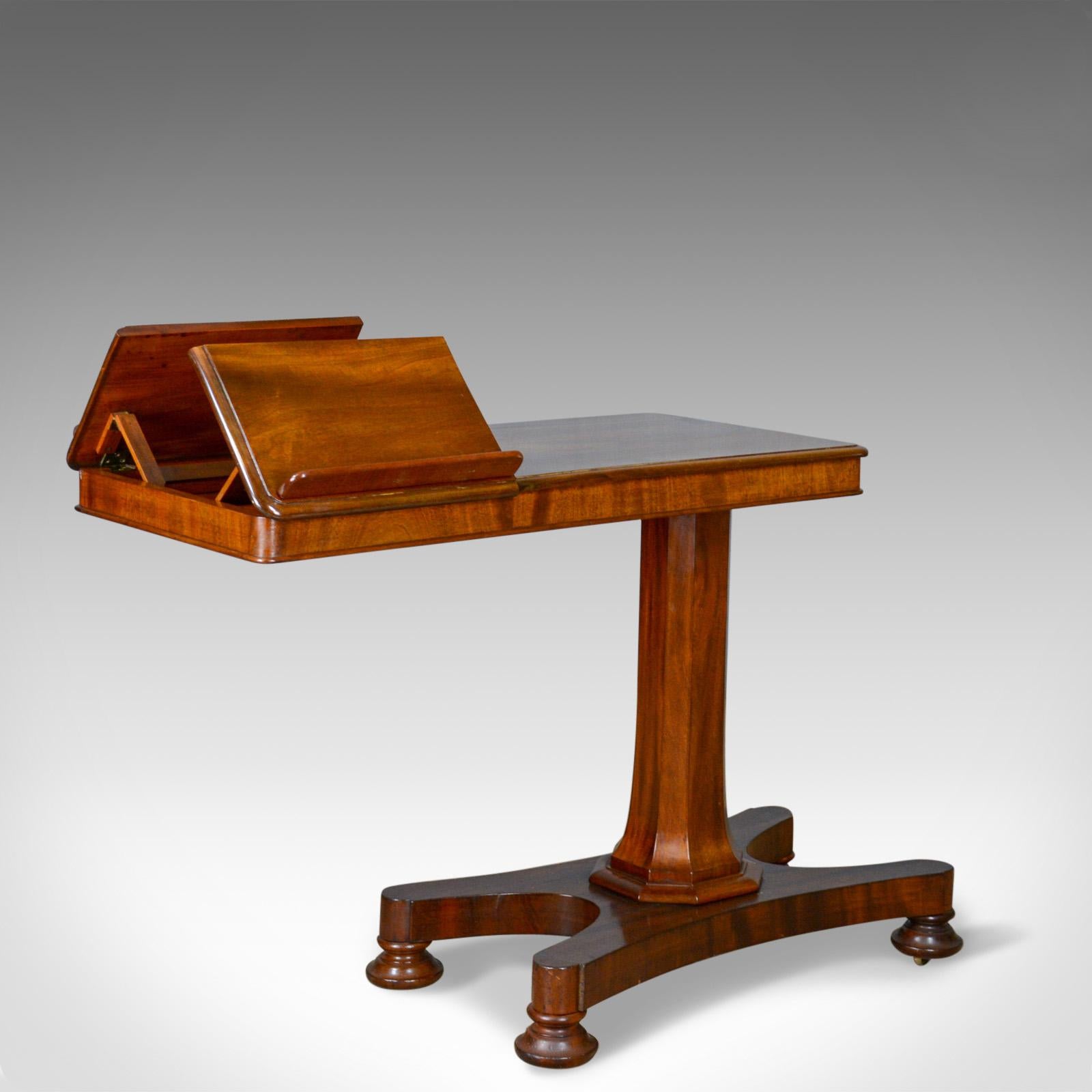 This is an antique reading table or duet music stand in the manner of Gillows, an English, Victorian, mahogany table dating to the mid 19th century, circa 1870.

Classic lines and of good proportion
Good consistent color with a wax polished