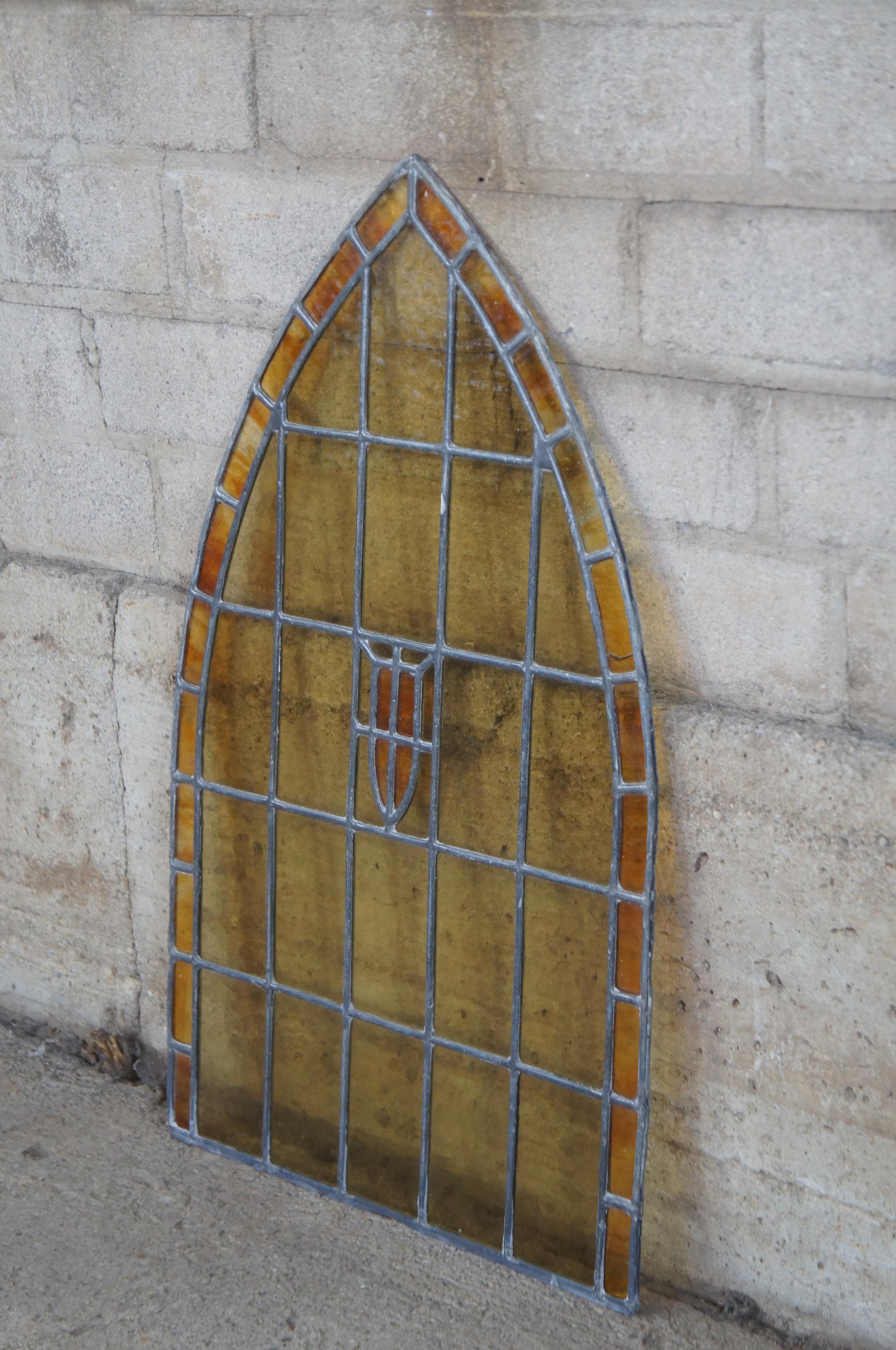 Antique Gothic or Victorian stained glass window pain. Features leaded stained and slag glass in arched shape. Architectural salvage / reclaimed. 5 available.
    