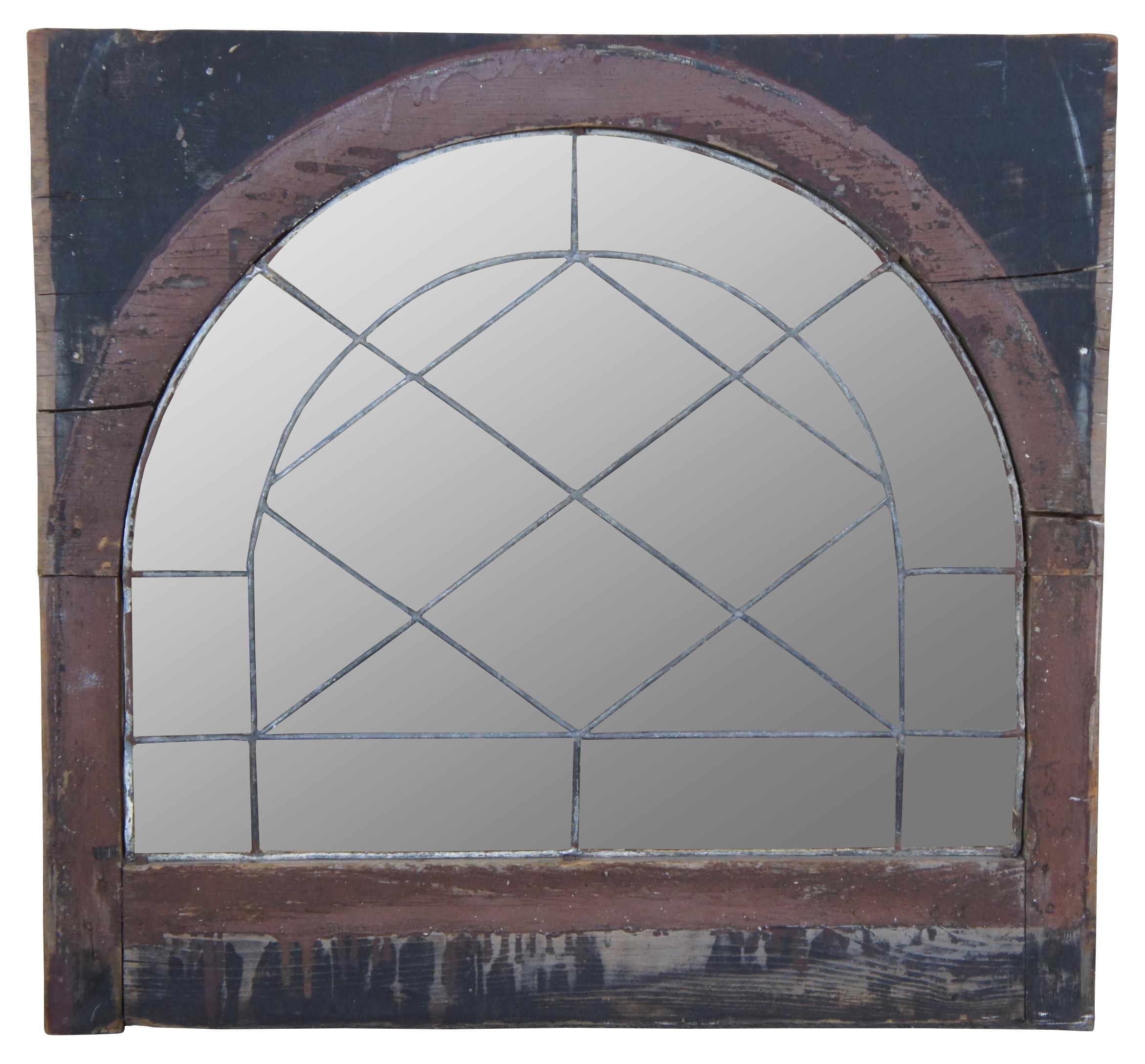 Antique reclaimed leaded and beveled glass arched transom window. Set in a rustic frame. Measure: 26
