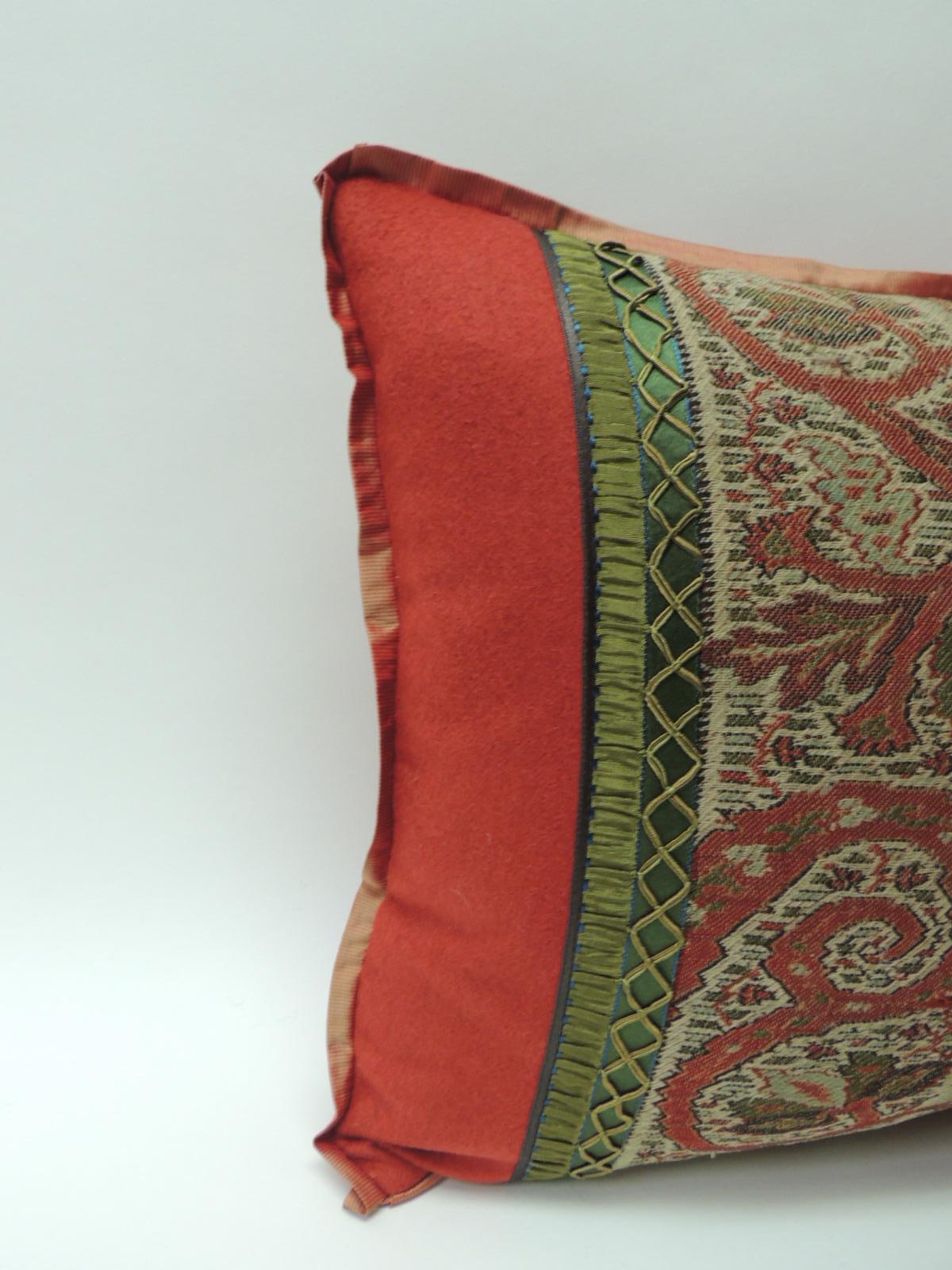 Antique red and black Kashmir Paisley Lumbar decorative pillow
Embellished with green woven braid trim frame with red wool, ATG
custom flat red silk trim and ren wool backing.
Decorative pillow handcrafted and designed in the USA. 
Closure by