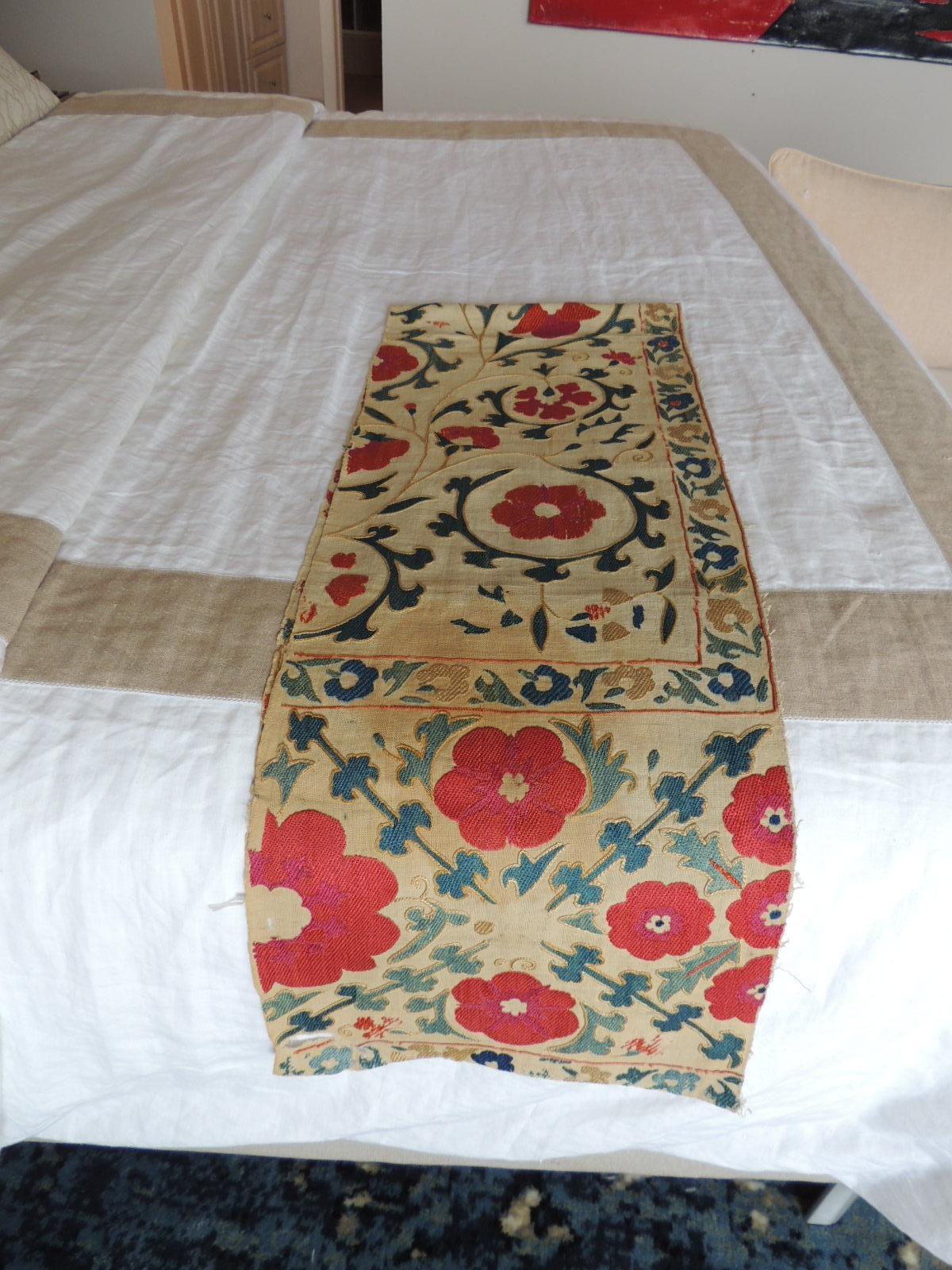 Antique red and green floral Suzani table Runner
Large and small embroidered flowers in shades of orange, green, blue, aqua, 
turquoise, yellow and natural.
Silk embroidered on linen.
Minor stains from age.
Size: 12