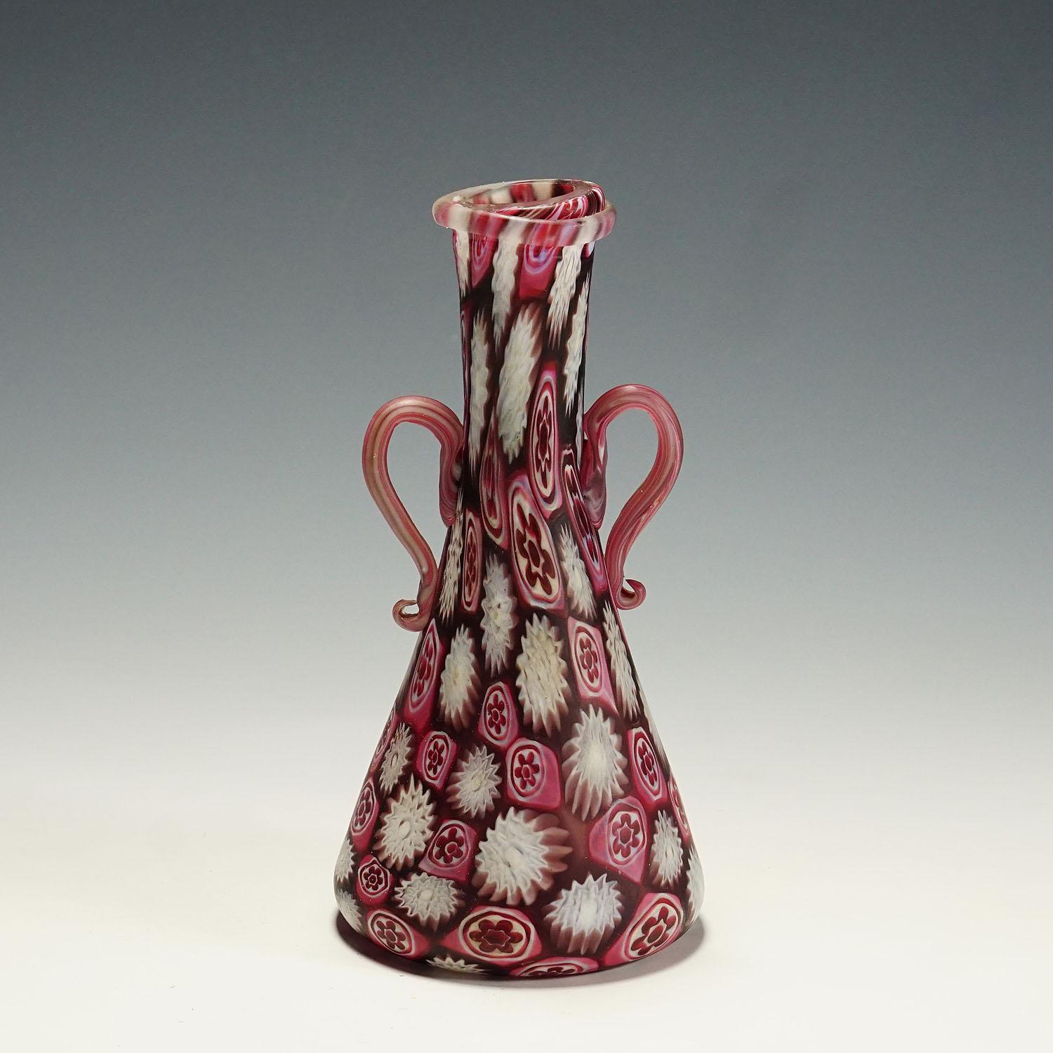 Antique red and white Fratelli Toso Millefiori vase, Murano circa 1910

A large Millefiore murrine glass vase, manufactured by Vetreria Fratelli Toso, Murano around 1910. Manufactured with polychrome murrines in pink, red and white and an acid