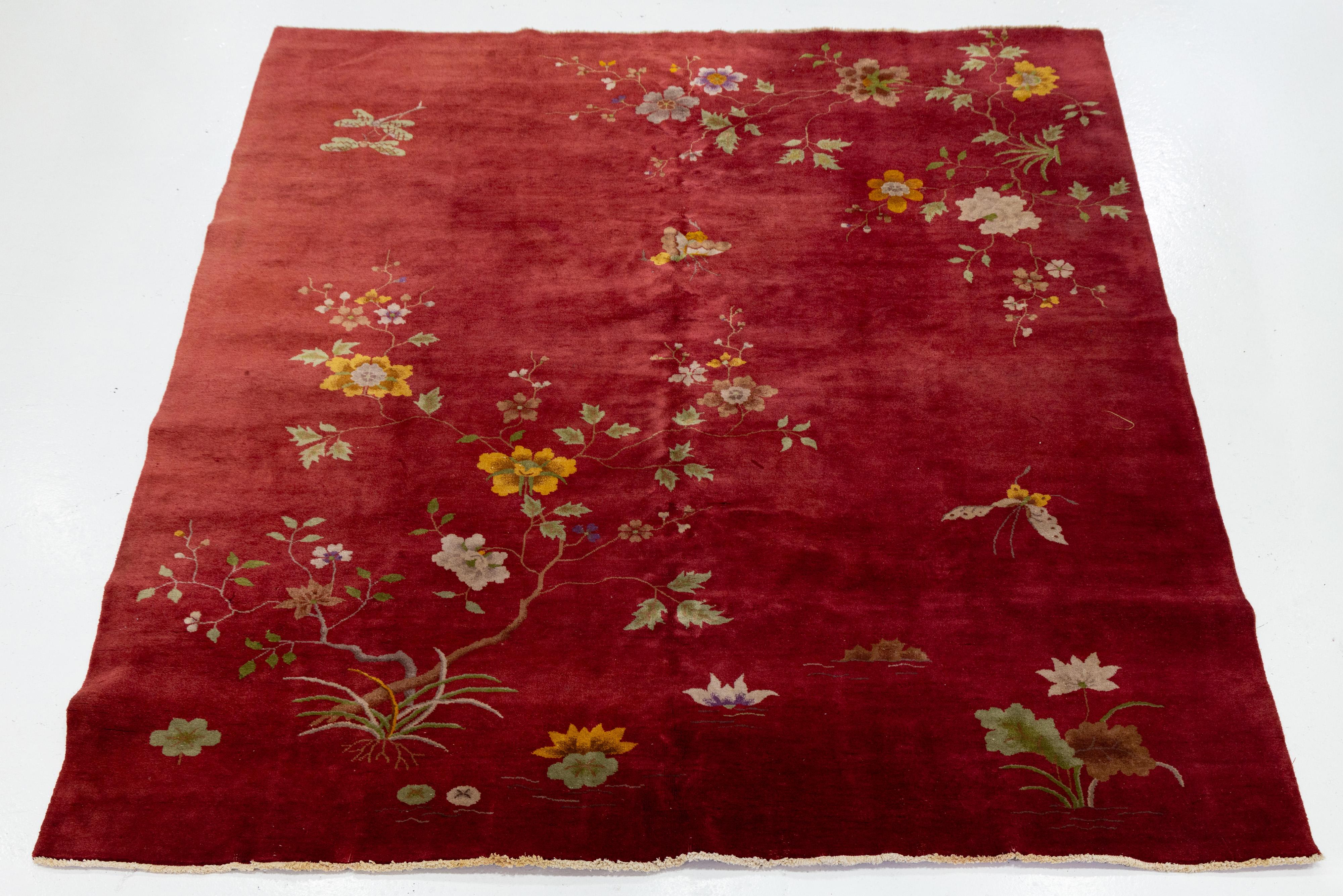 Beautiful antique Chinese Art Deco hand knotted wool rug with a red field. This Chinese rug has multi-color accents in a gorgeous all-over Classic Chinese floral design.


This rug measures: 8'1