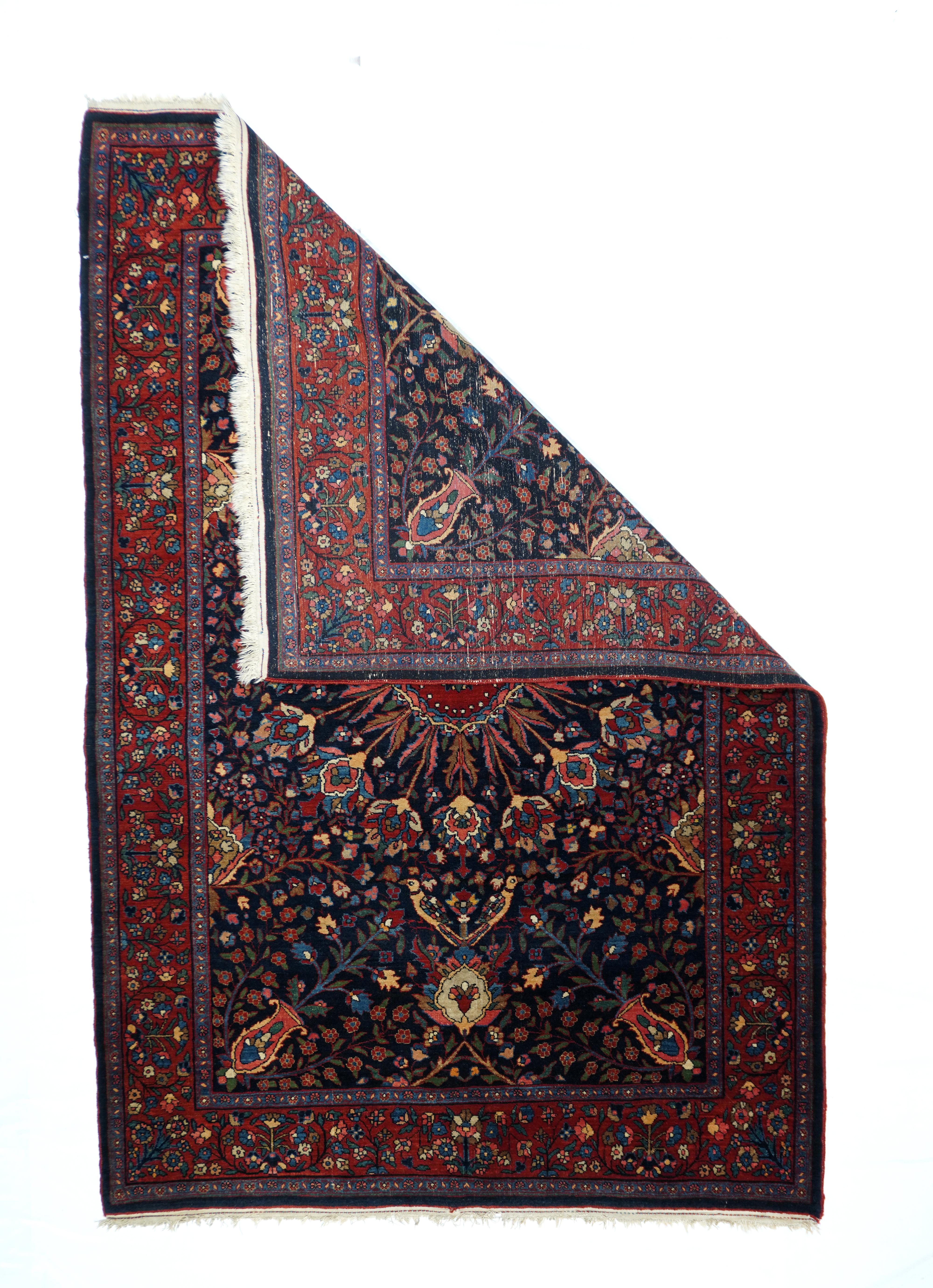This well-woven Kurdish town scatter shows a radiating 16-palmette and leaf flowerhead pattern on a rich navy ground. Field corner diagonal vases. Wine red border of rosette sprays and upright whole flowers. Compact construction with short, but