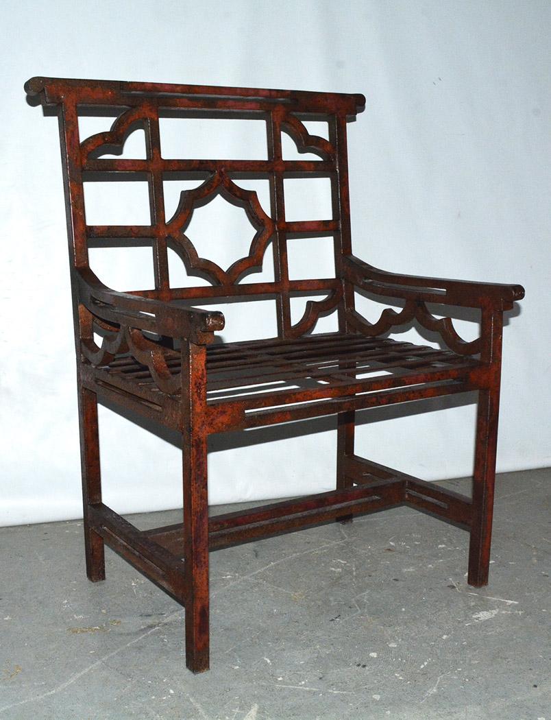 Highly stylish, classical form of a English garden chair, sometimes referred to as “chinoiserie” style, but also known in Britain as “cockspen” chairs. This chair is large and commodious. The garden/patio chair still have evidence of red paint, the