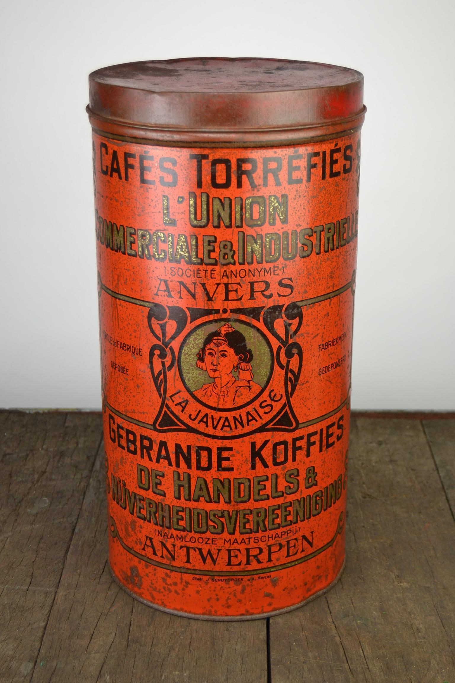 Antique red tole coffee tin from Antwerp, Belgium.
A tube shaped coffee storage box with lid dates circa 1920s. 
This Belgian round coffee tin from the Art Nouveau period has great lettering and a women or lady on the box. A coffee container with