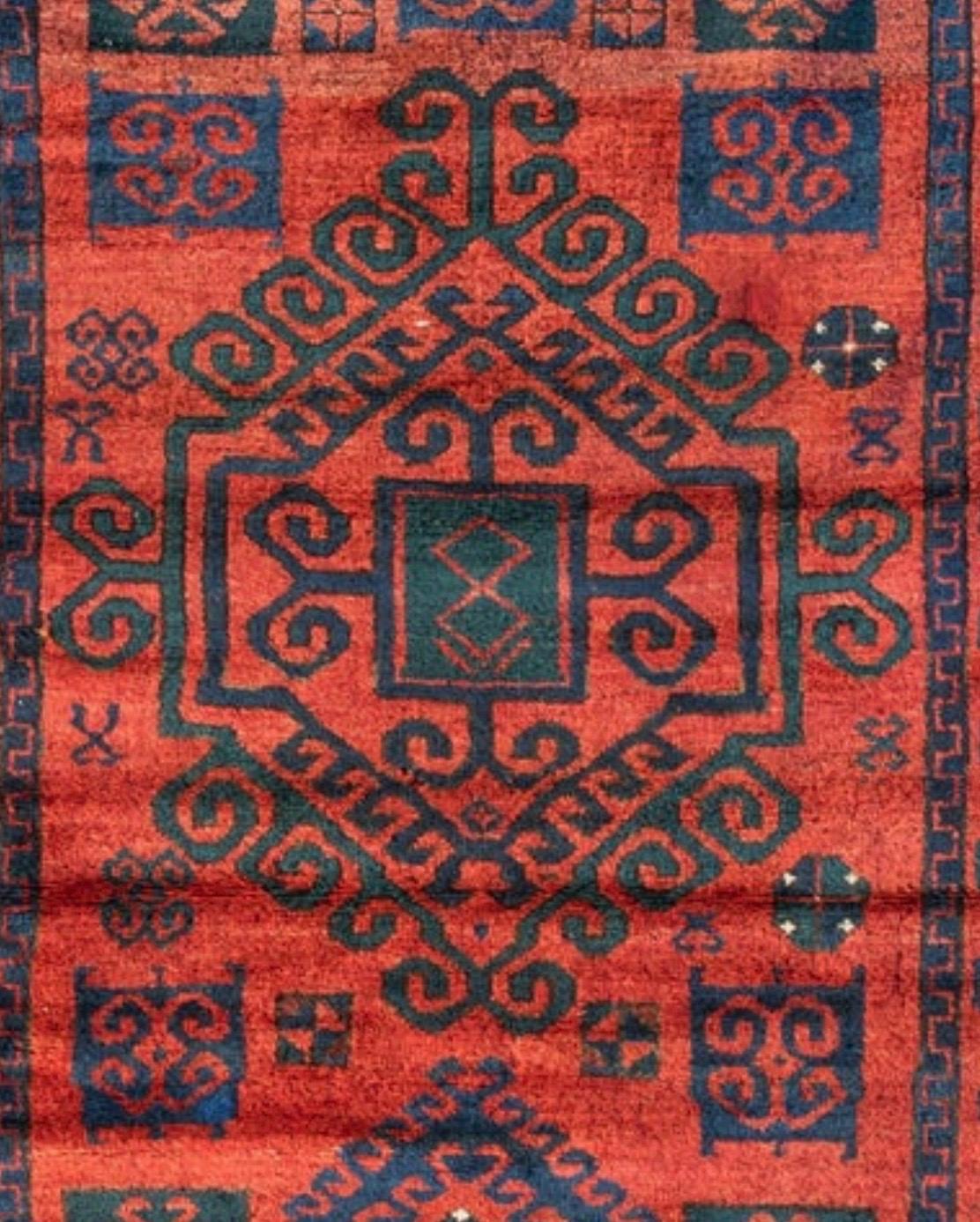 This is a lovely hand-woven antique Afcan rug from the 1930s measuring 4.4 x 6.7 ft.