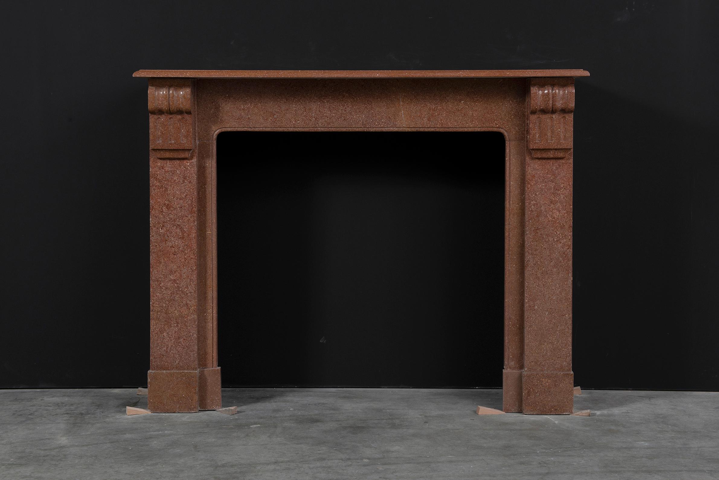 Lovely little French Louis Phillipe style fireplace in war deep red marble.
Nice rectangular and profiled topshelf above two simple but decorative corbels on straight jamb above plain endblocks.

Great proportions. Opening is almost square which
