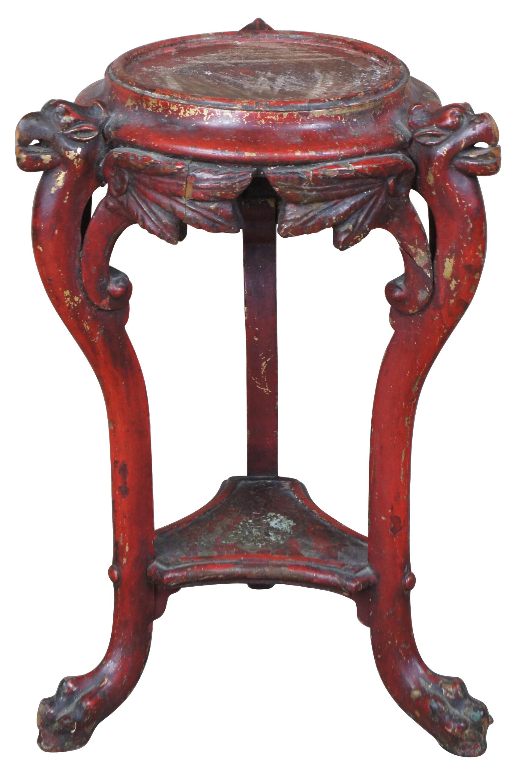 Antique red painted figural winged animal table. Features a Griffin (Gryphon, Griffon), eagle or dragon figure carved out of wood and painted red over gold. A two-tier design with ornate detail and paw feet.
  