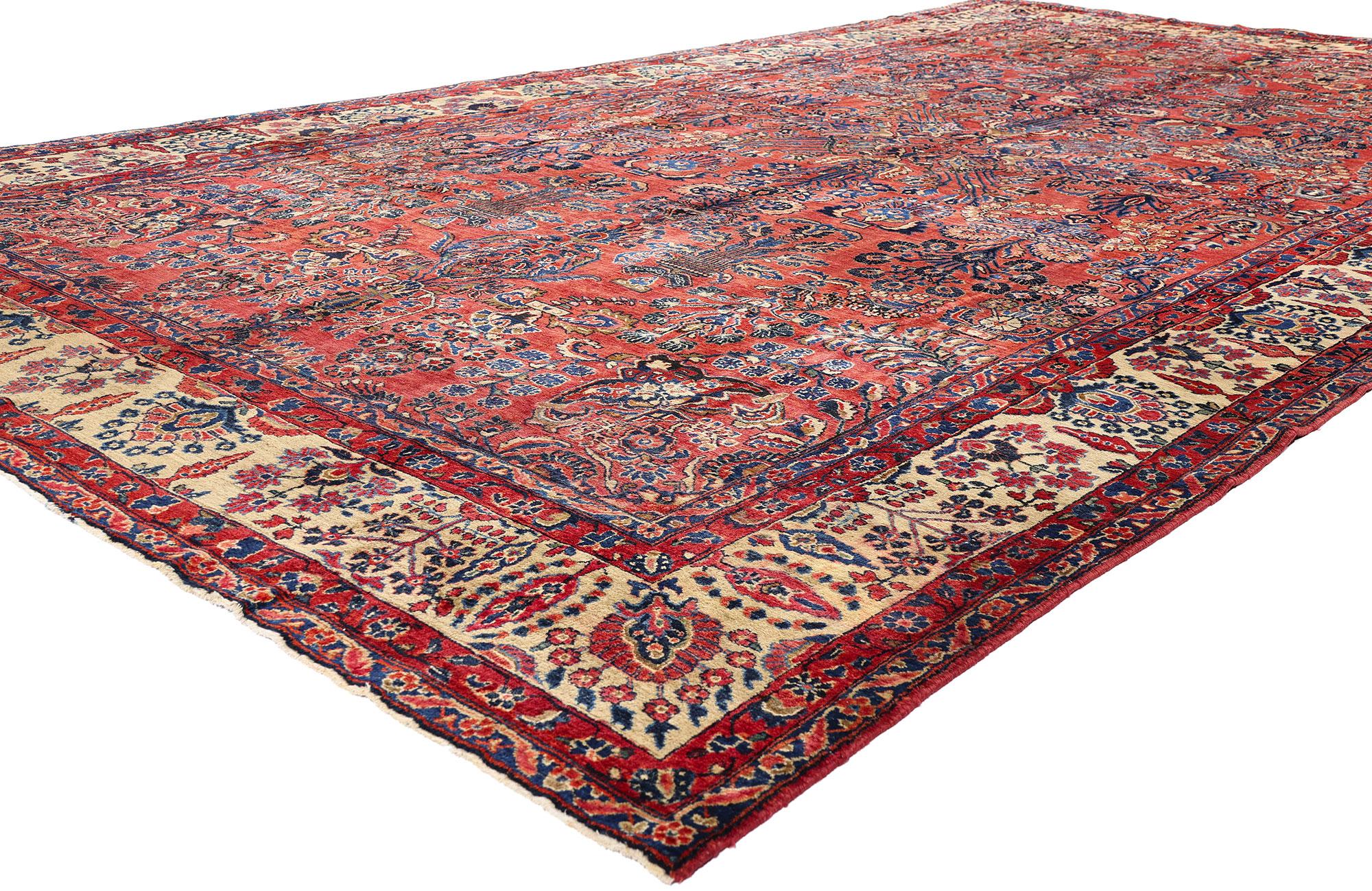 79222 Antique Red Persian Sarouk Rug, 08'08 x 15'07. This hand-knotted wool antique Persian Sarouk rug is a masterpiece of ornamental storytelling and technical prowess, steeped in the heritage of early 20th-century Persia. Radiating from a bold red