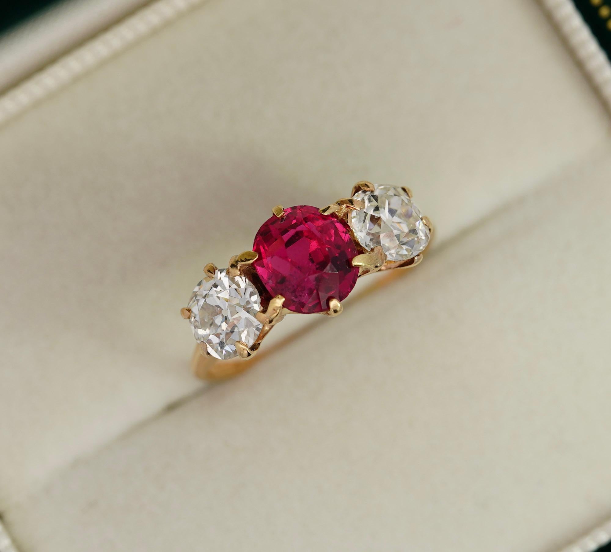 Antique Spinel and Diamond Three Stone Ring. Set with 4 carats total in natural gemstones. 

This antique circa 1920 ring features a vibrant 2.50-carat oval-cut red spinel center stone, paired with additional old mine diamond side stone detailing.