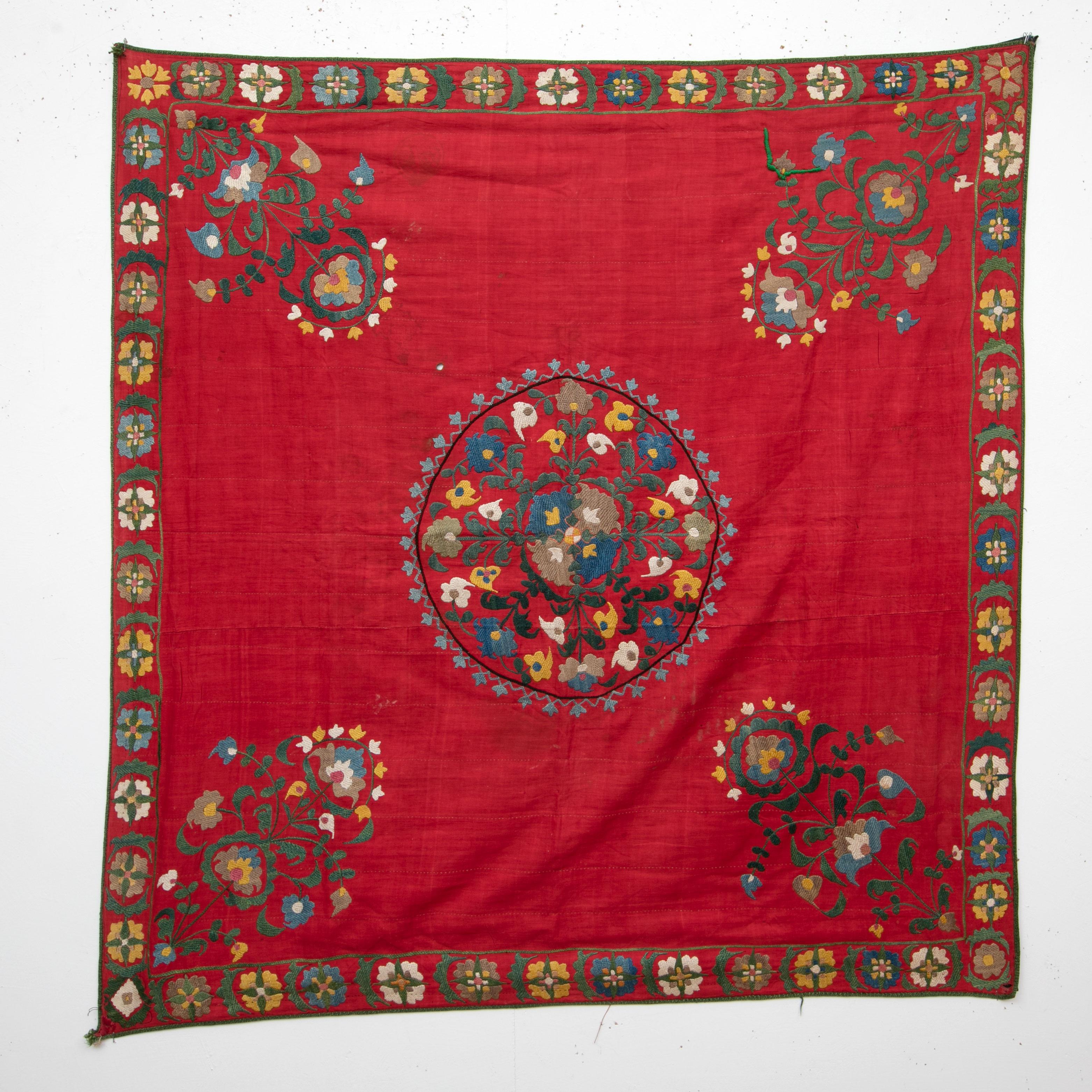 A squarish antique suzani from Tashkent Uzbekistan dating probably back to 1880s. The small square format suzanis are used in special occasion to wrap valuables and gifts. 
The suzani is being offered as found. It still has its original lining of