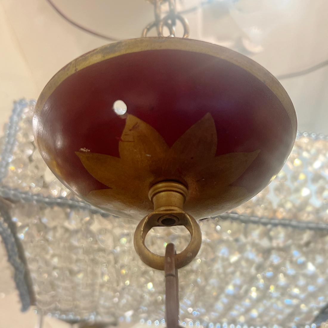 A French circa 1920's painted tole chandelier with gilt details with 5 candelabra lights.

Measurements:
Present drop: 27