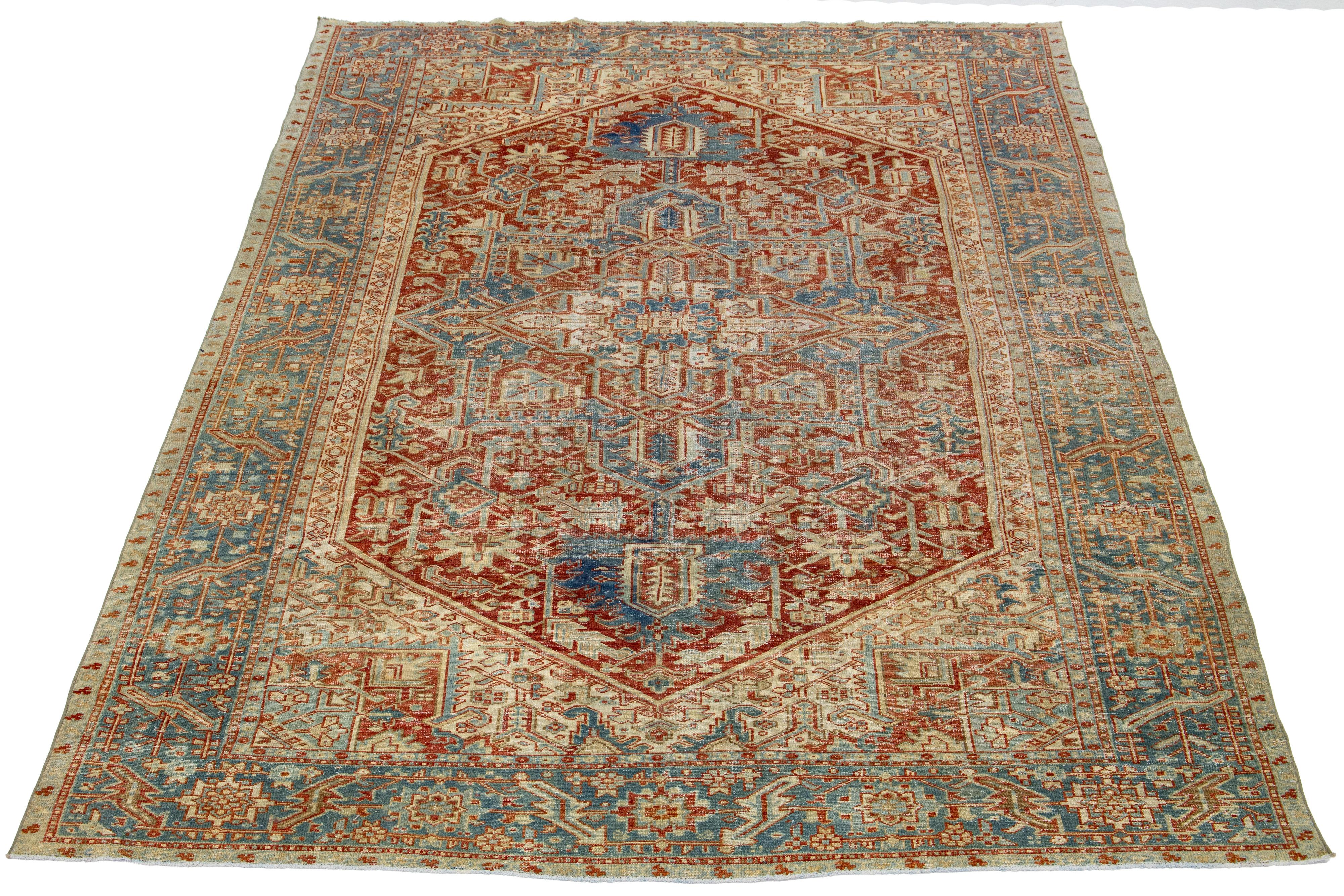 This hand-knotted wool Persian Heriz rug showcases a stunning allover pattern in shades of blue, brown, and ivory on a red-rust field.

This rug measures 7'11' x 11'.

Our rugs are professionally cleaned before shipping.