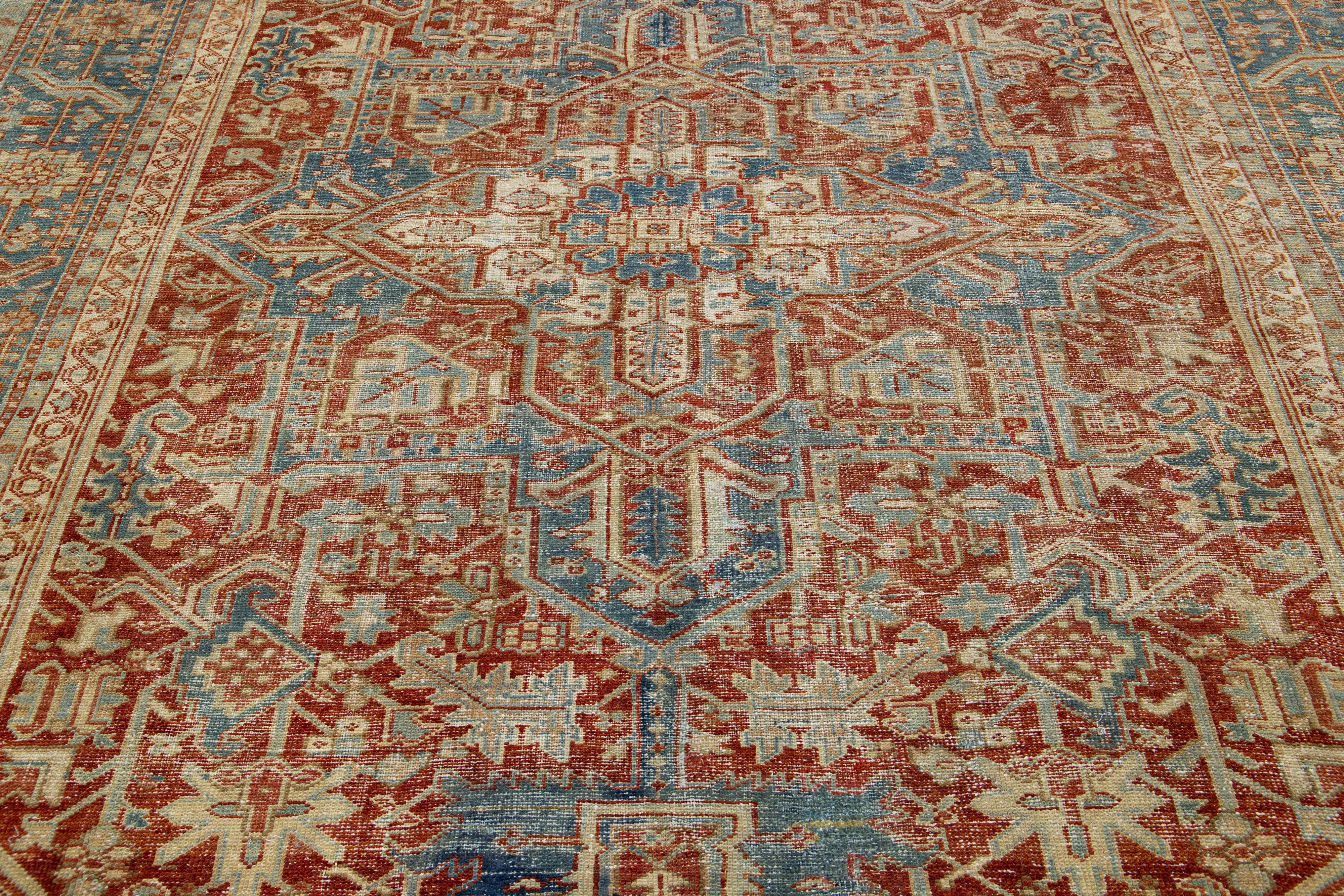 Early 20th Century Antique Red Wool Rug Persian Heriz Featuring a Medallion Motif  For Sale