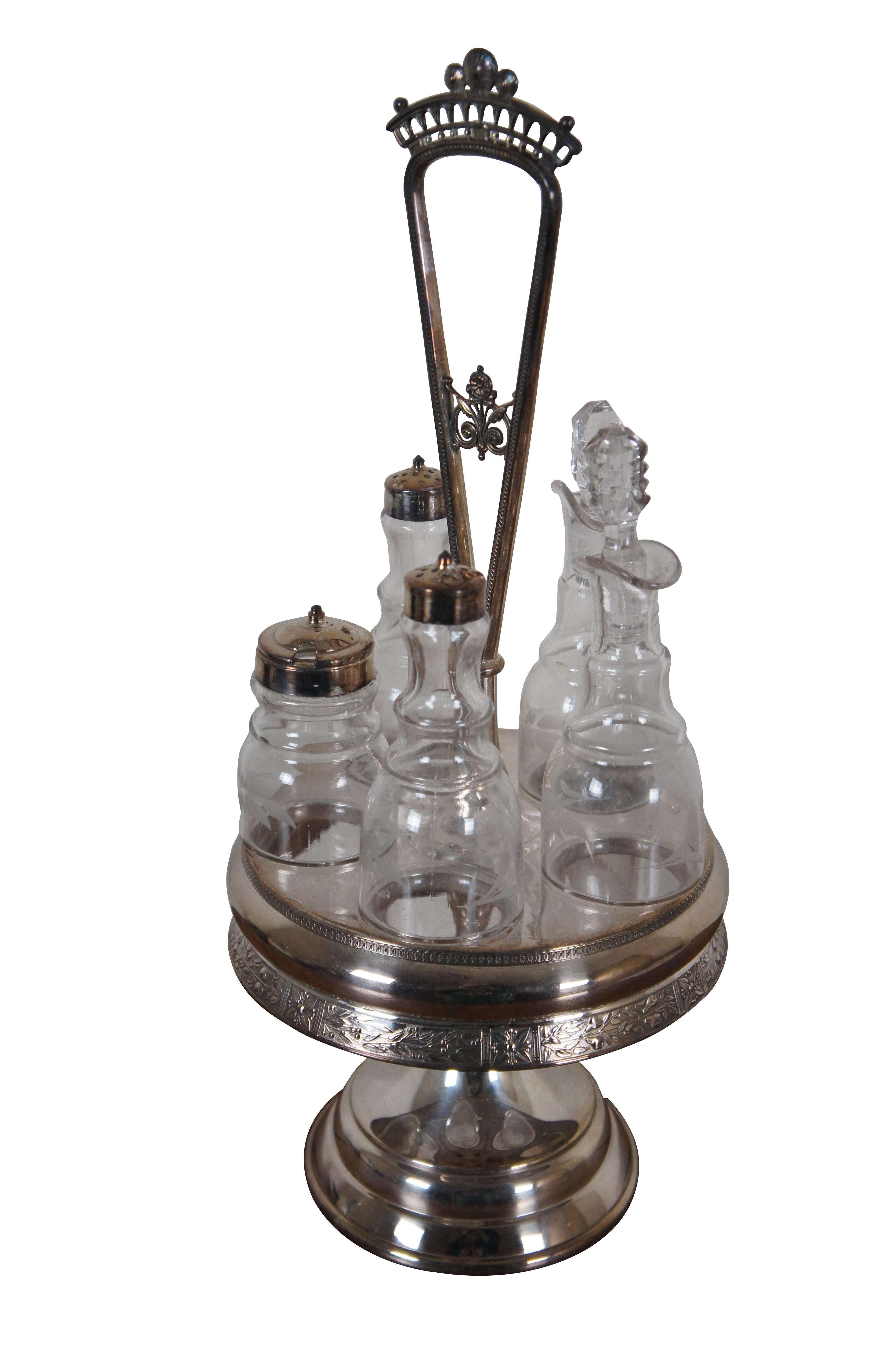 Antique Victorian Reed & Barton cruet condiment set featuring pressed and etched glass bottles with ornate footed silverplate caddy

