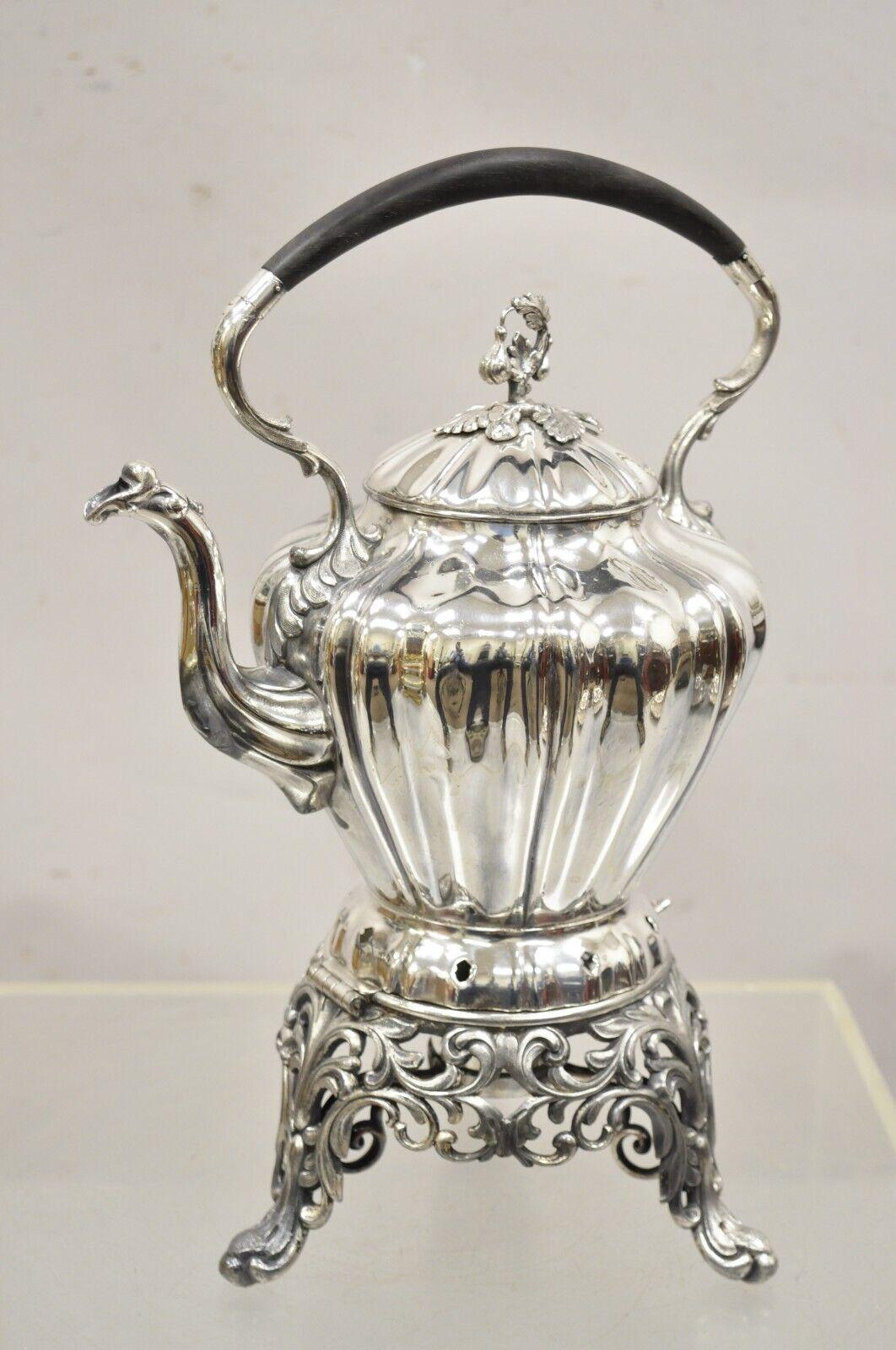 Antique Reed & Barton Silver Plated Victorian Tilting Tea Coffee Pot on Stand. Item features has a pierced decorated base, wooden handle, maple leaf and vine lid, original hallmark, nice tilting form with original chain. Circa 1900. Measurements: