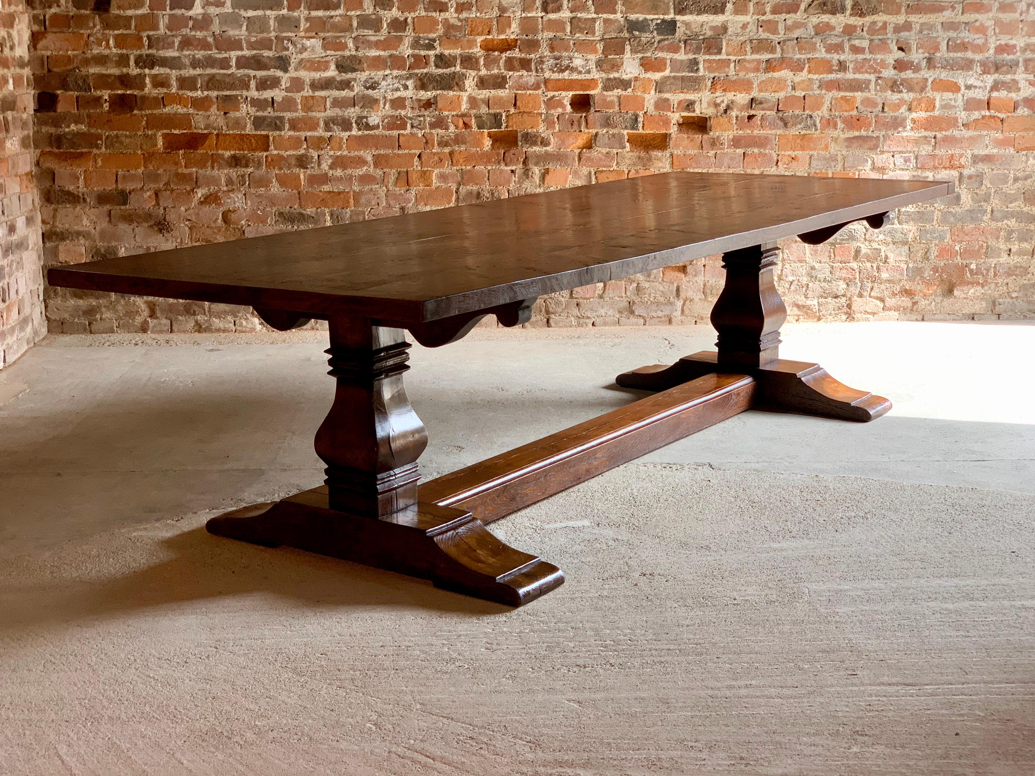 A magnificent top quality antique Bylaws 17th century style solid oak refectory dining table of large proportions seating 10 people comfortably, the solid rectangular planked top rests on a twin bulbous baluster base joined by a single full length