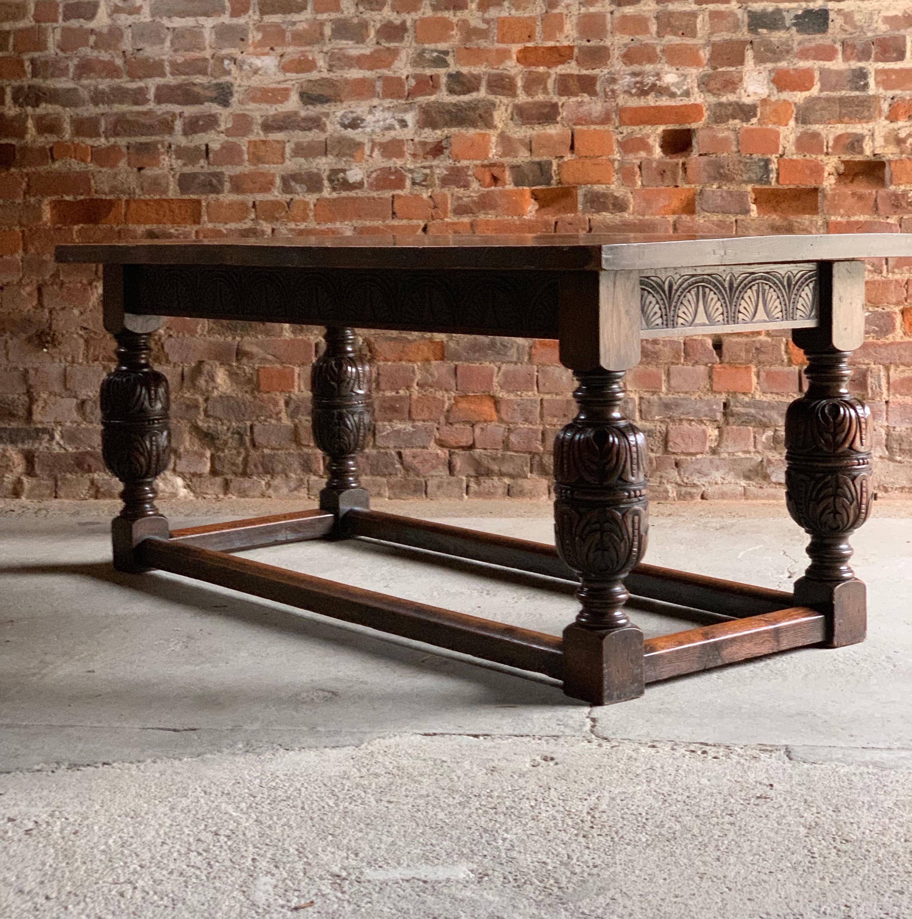 
Fabulous and practical 17th century style solid oak refectory dining table with six oak chairs circa early 20th century, the two oak plank top above a carved frieze, raised on turned supports united by stretchers on bulbous turned and carved legs,