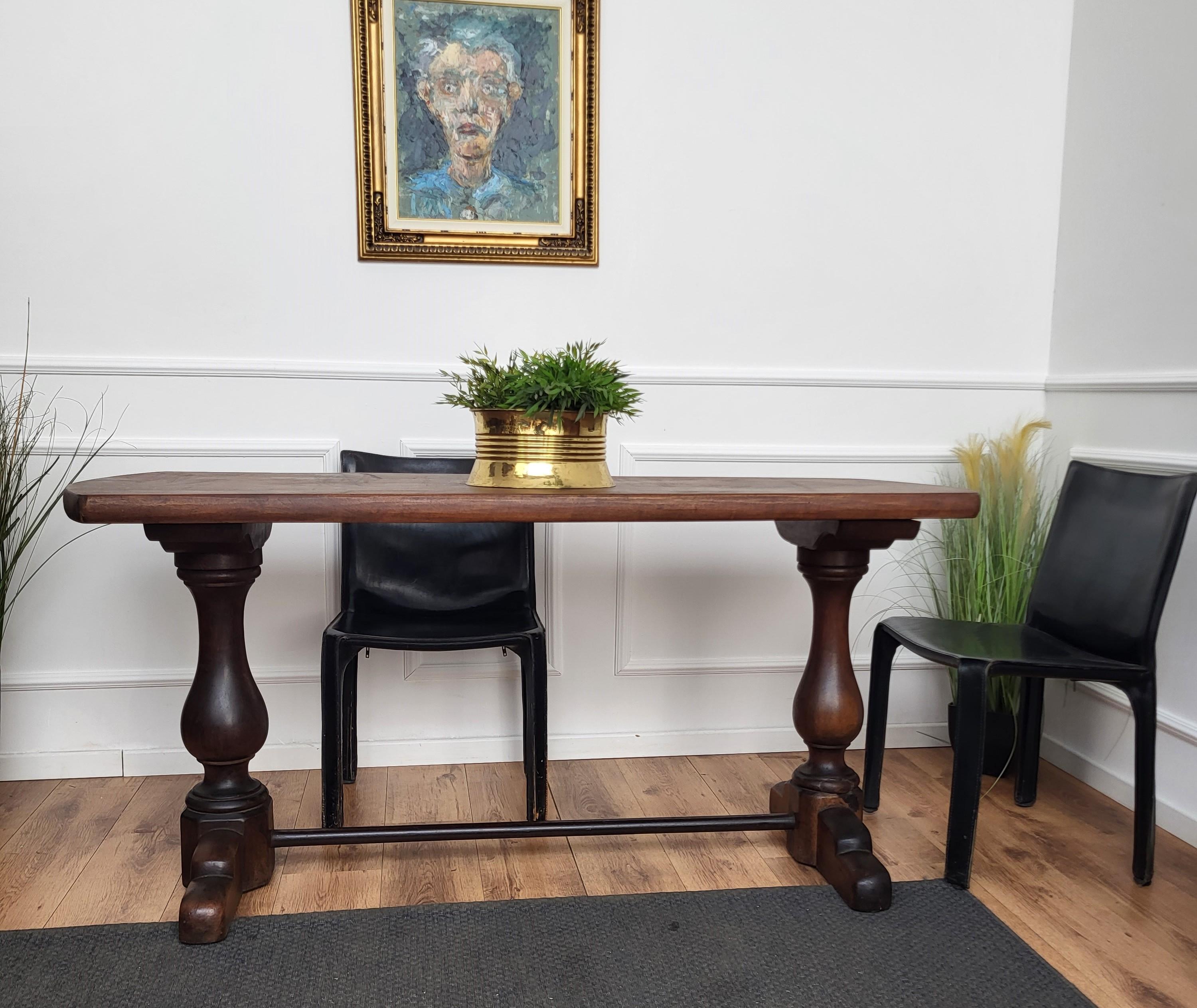 A beautifully crafted Italian refectory table with a thick top and marvellous construction and design on the trestle base. The carving on the feet adds an additional note of interest. Great color and rich patina complete the look. Solid wood