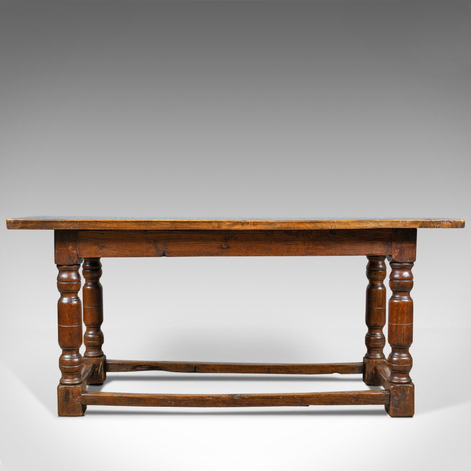 This is an antique refectory table. An English, Elm, dining or console table dating to the early 18th century and later.

Unusual to find a refectory table in elm
Crafted in well-figured, stout stocks of English elm 
Attractive grain detail in the