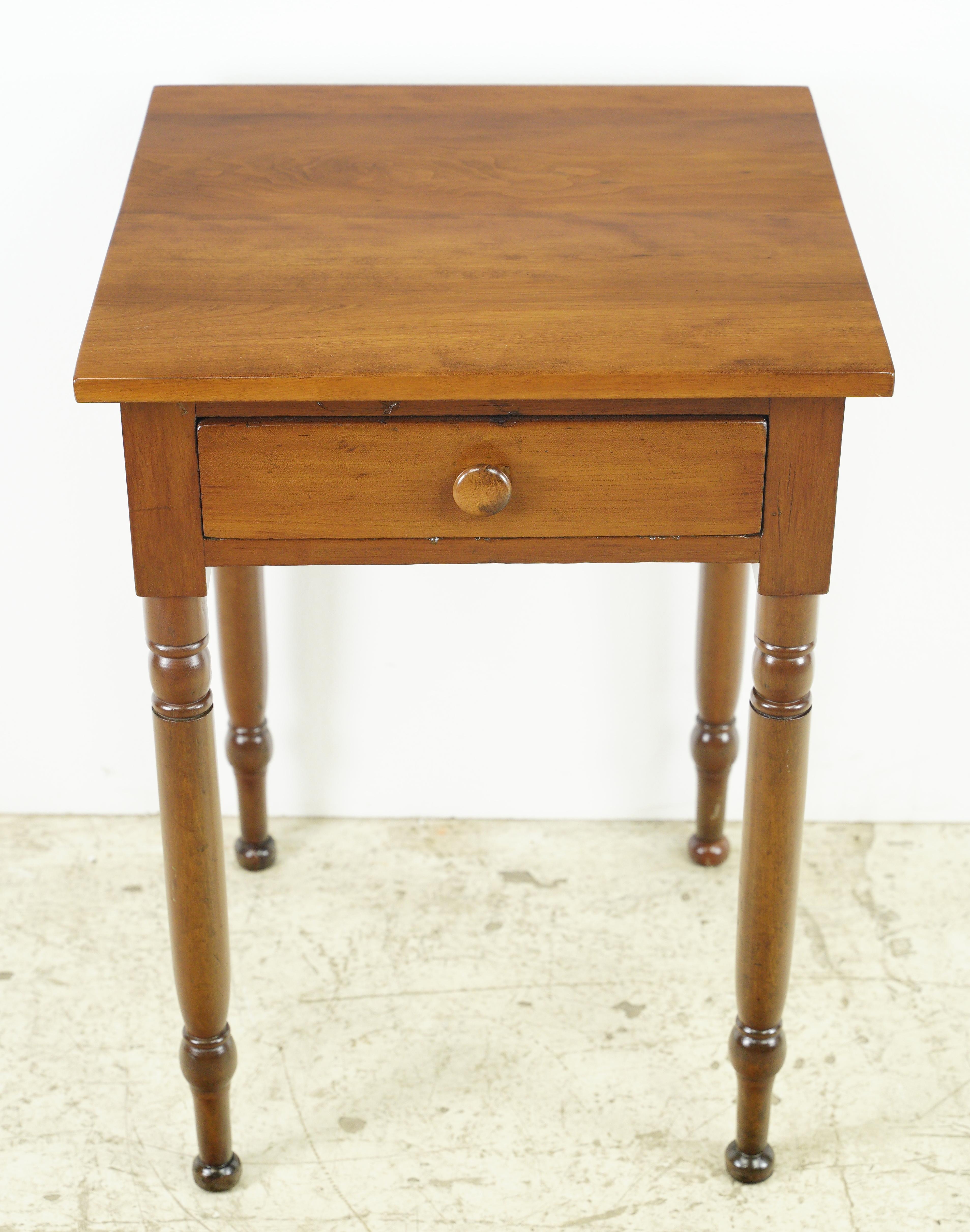 This antique end table is a charming and timeless piece of furniture. Crafted from cherry wood, it features a square design with a single drawer. The fact that it has been refinished suggests that it has been carefully restored to its former glory,