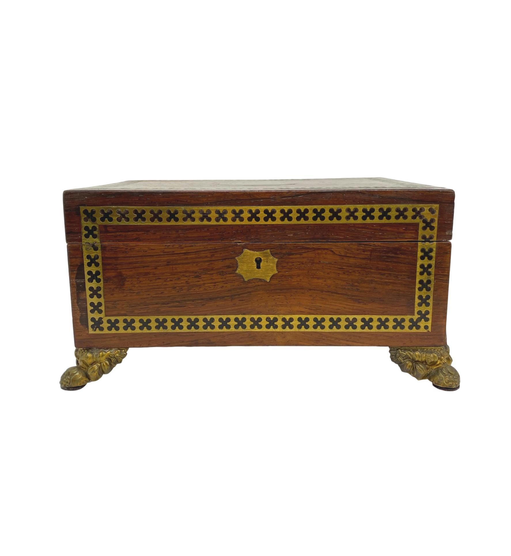 Antique Regency box in rosewood with inlaid ebony and brass decorative bands, with exceptional brass hardware, English, circa 1820.