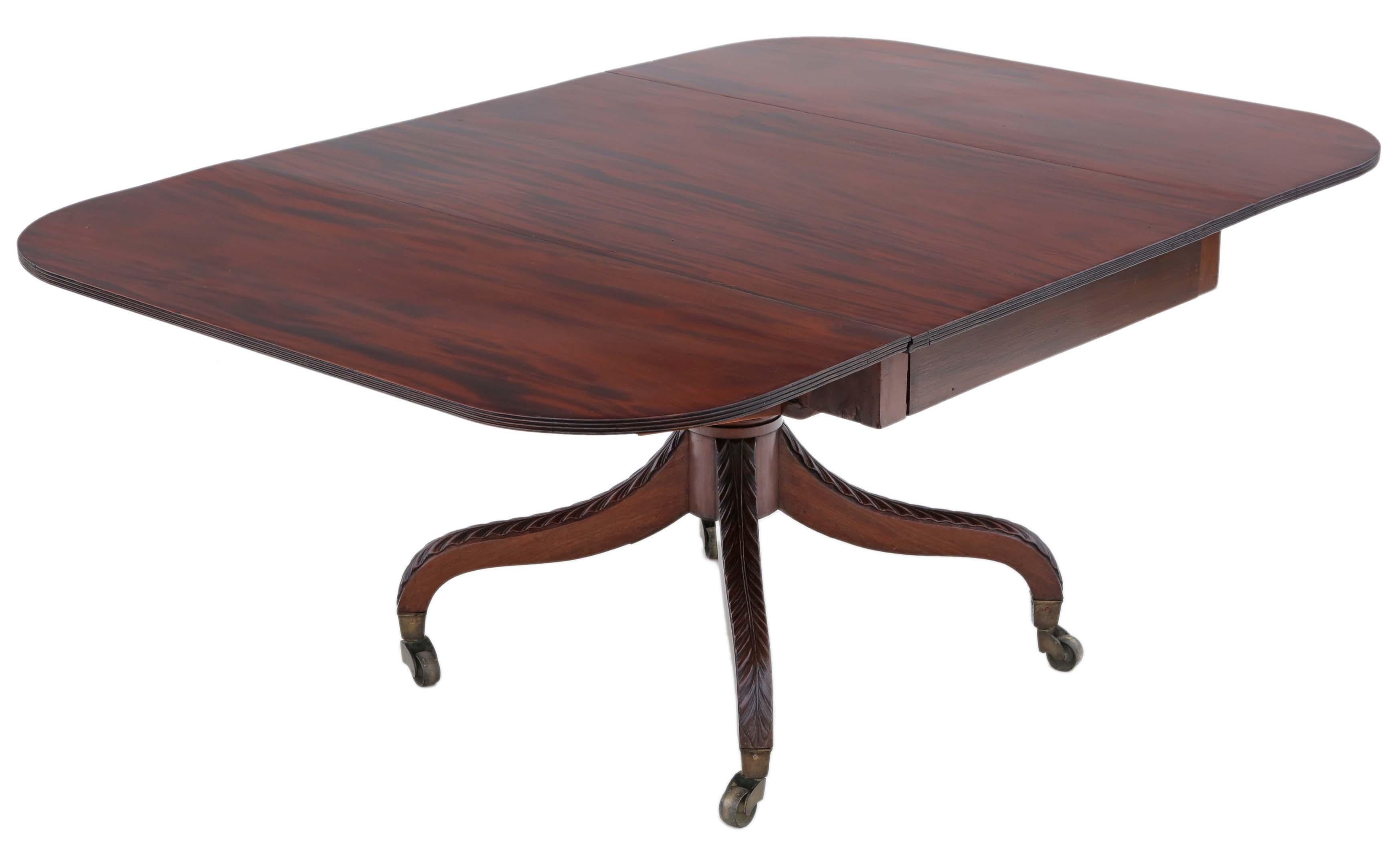 Antique Regency circa 1825 Cuban mahogany drop-leaf dining table.

This is a lovely table, that is full of age, charm and character. Lovely patina and color, with a magnificent 4-leg pedestal base and huge period brass cup castors.

Very rare