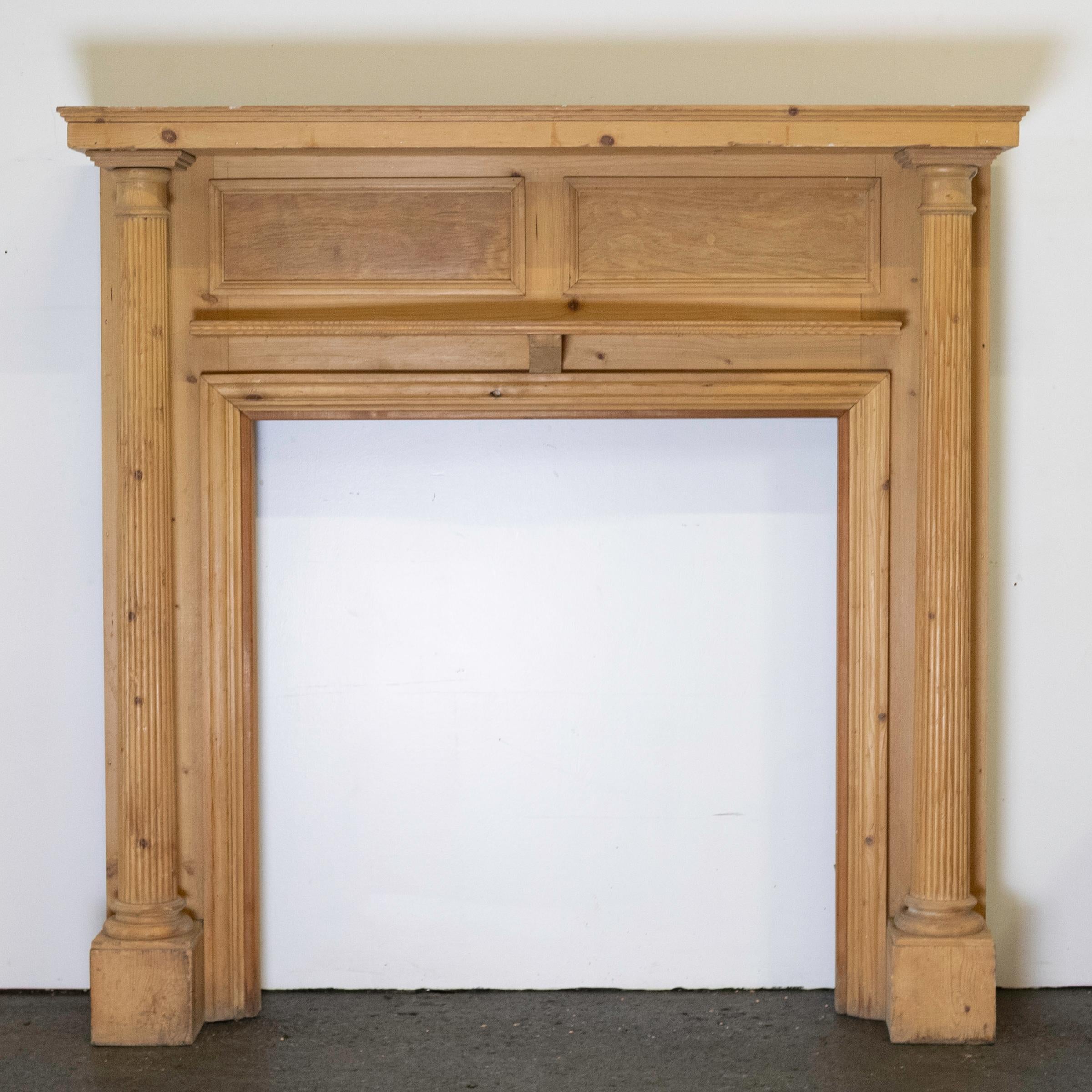 Antique Georgian carved fireplace surround in pine.

This wooden fireplace surround features finely carved detailing, reeded columns, a bow-fronted shelf and panelled frieze.

A handsome piece for a period renovation.

Dimensions:
Shelf: 138.5cm