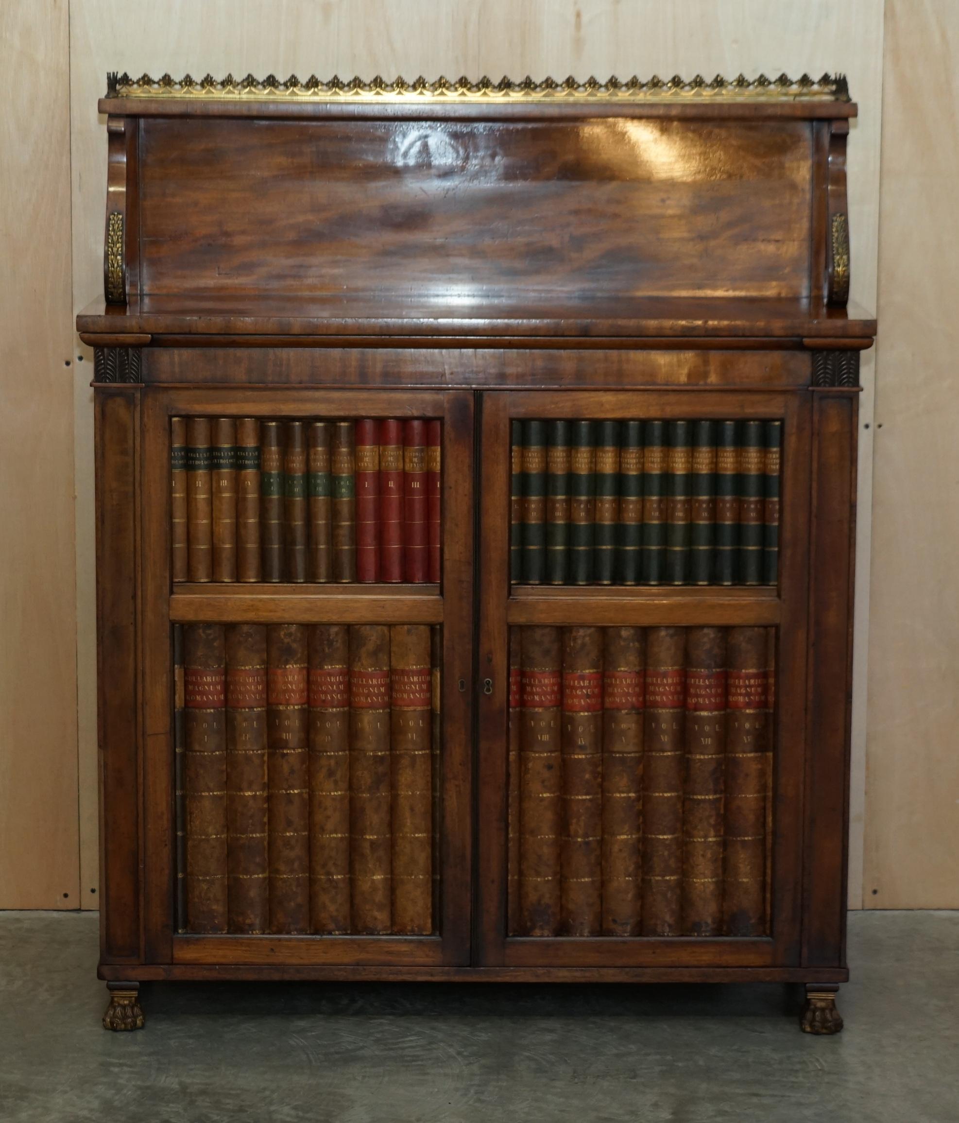 Royal House Antiques

Royal House Antiques is delighted to offer for sale this stunning original circa 1815 Regency Mahogany Brass and Leather chiffonier sideboard with gallery rail and faux book front

Please note the delivery fee listed is just a