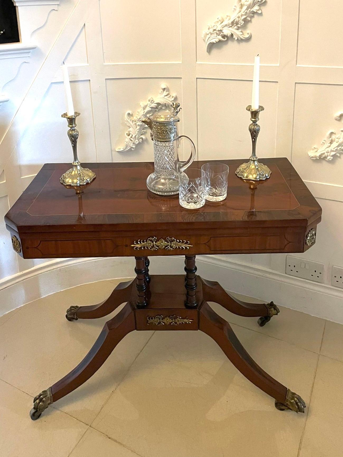 Fine quality antique regency figured mahogany card/console table with gilded brass mounts having a fine quality figured mahogany swizzle top crossbanded in rosewood and satinwood  inlaid stringing opening to reveal a red baize interior, mahogany