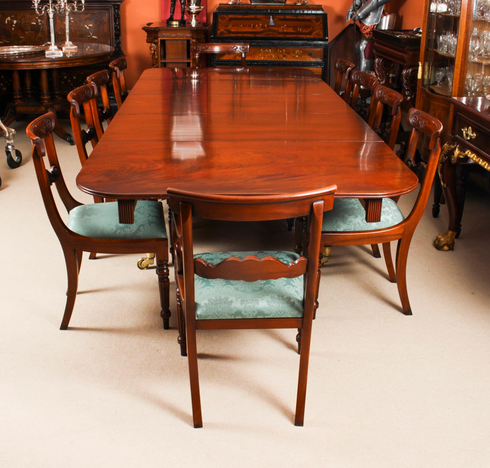 A very rare opportunity to own a fabulous dining set comprising an antique Regency dining table, Circa 1820 in date, and a set of twelve Vintage Regency Revival dining chairs.

The table is made of beautiful solid flame mahogany. This can be seen in