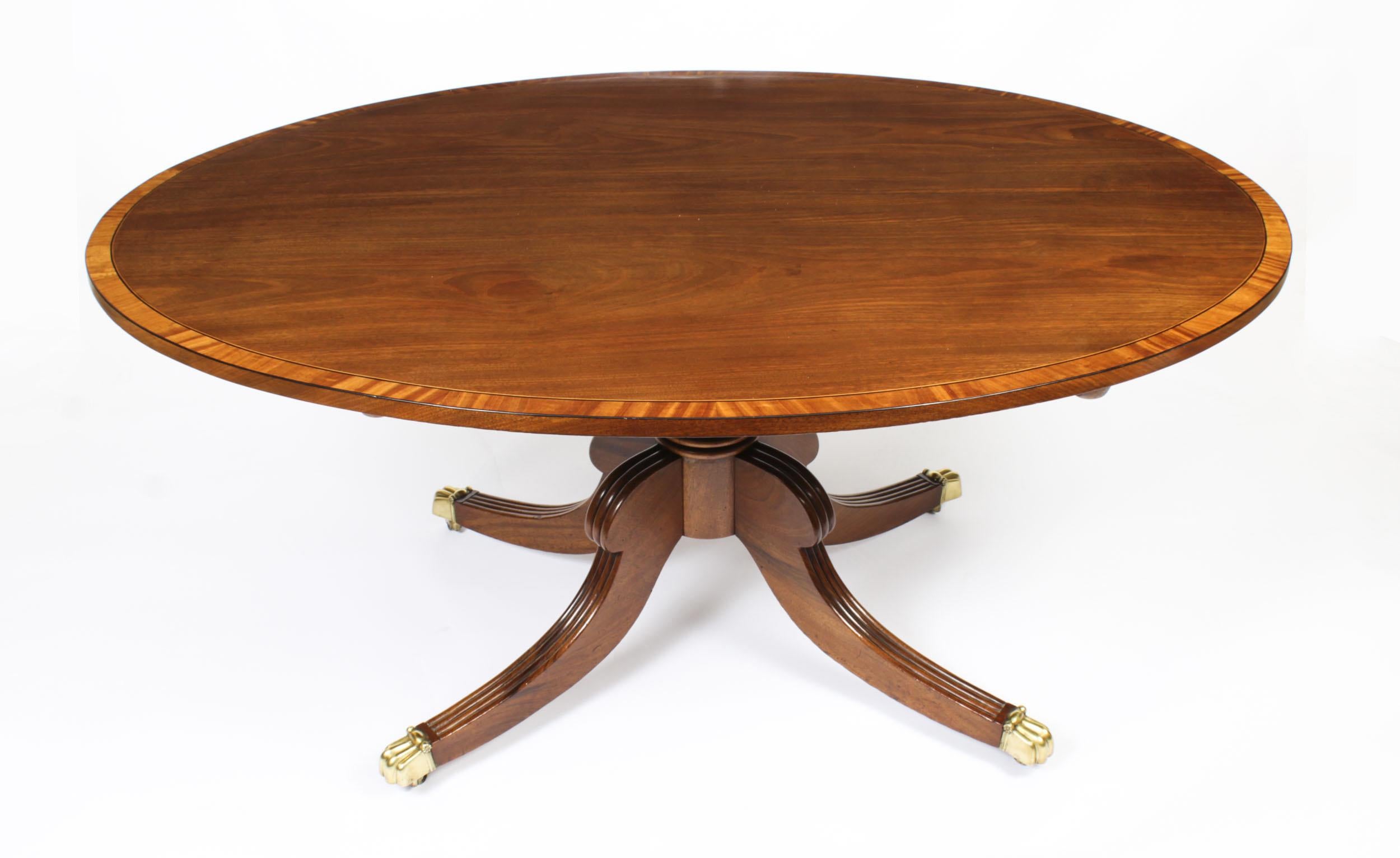 This is a beautiful antique Regency flame mahogany and Satinwood banded tilt top oval dining table dating from circa 1820 with a set of six Regency Revival dining chairs dating from the 20th century.

The fabulous 5ft flame mahogany tilt top table
