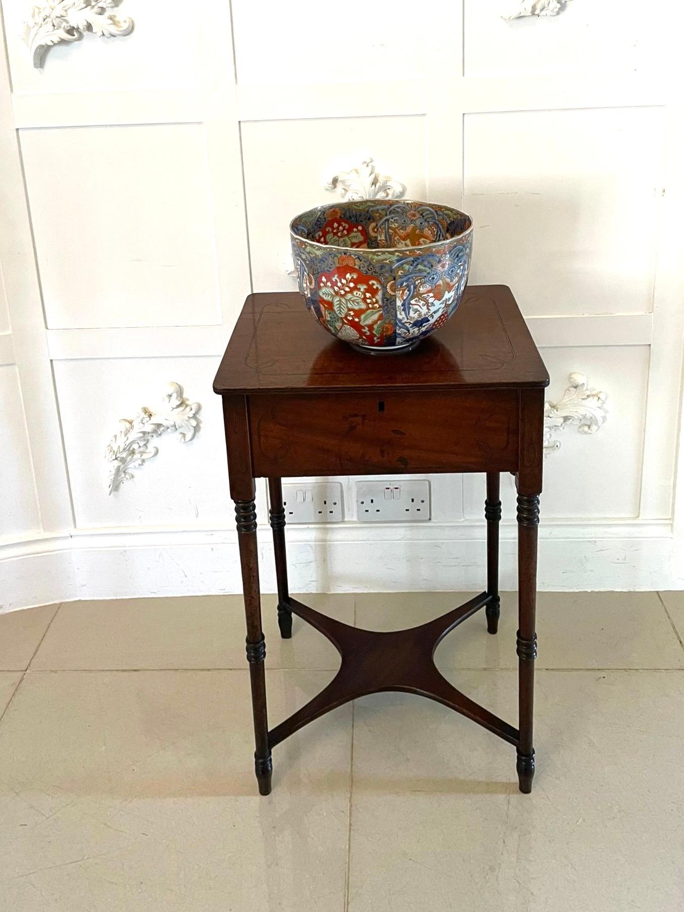 Antique Regency freestanding quality mahogany inlaid lamp table having a quality mahogany inlaid lift top with a reeded edge opening to reveal a storage compartment, inlaid mahogany frieze standing on elegant turned tapering legs with turned feet