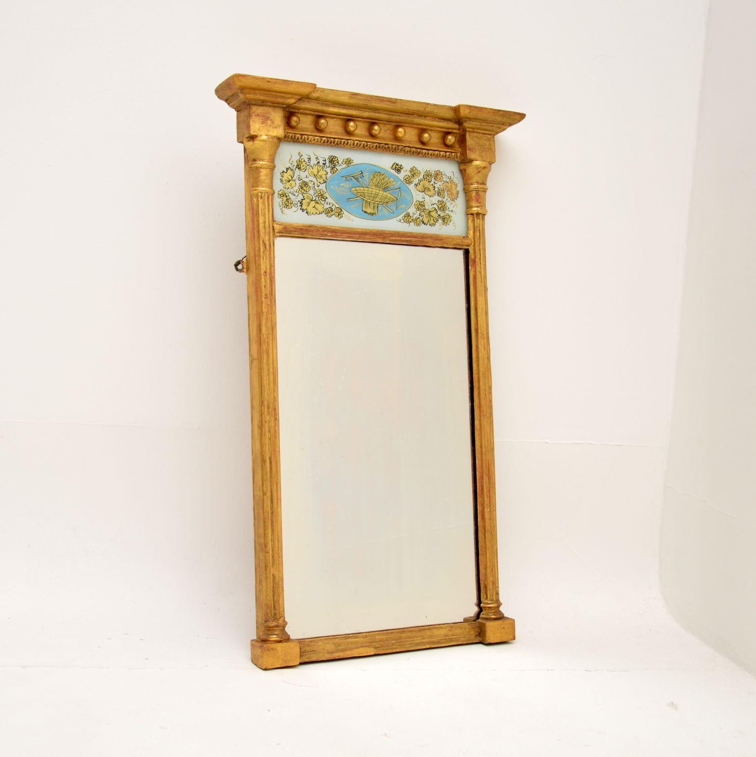 A smart and very well made antique Regency gilt wood mirror. This was made in England, it dates from around the 1800-1820 period.

It is of lovely quality and is a very useful size. The gilt wood has a fantastic patina, there are lovely details and
