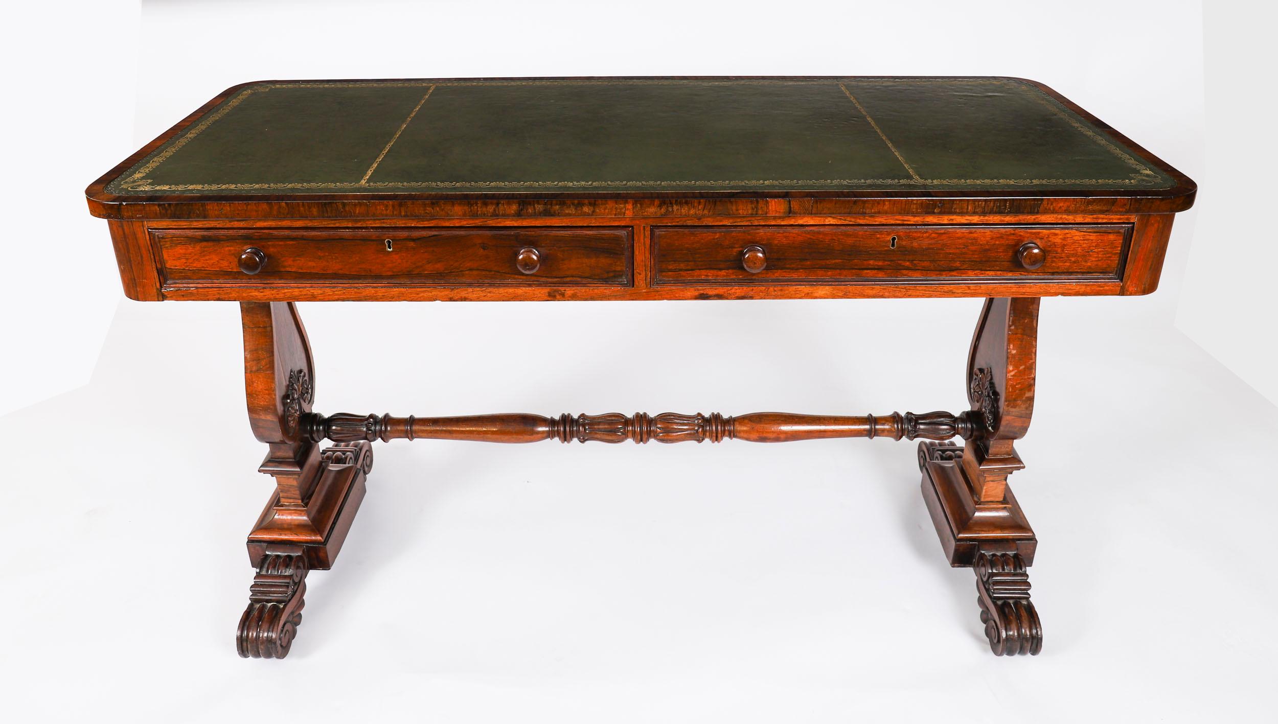 This is a fabulous antique Regency Period Gonçalo Alves library table, circa 1820 in date.

The desk is crafted from  beautiful Gonçalo Alves and features a striking inset gold tooled green leather writing surface.

It has two frieze drawers with