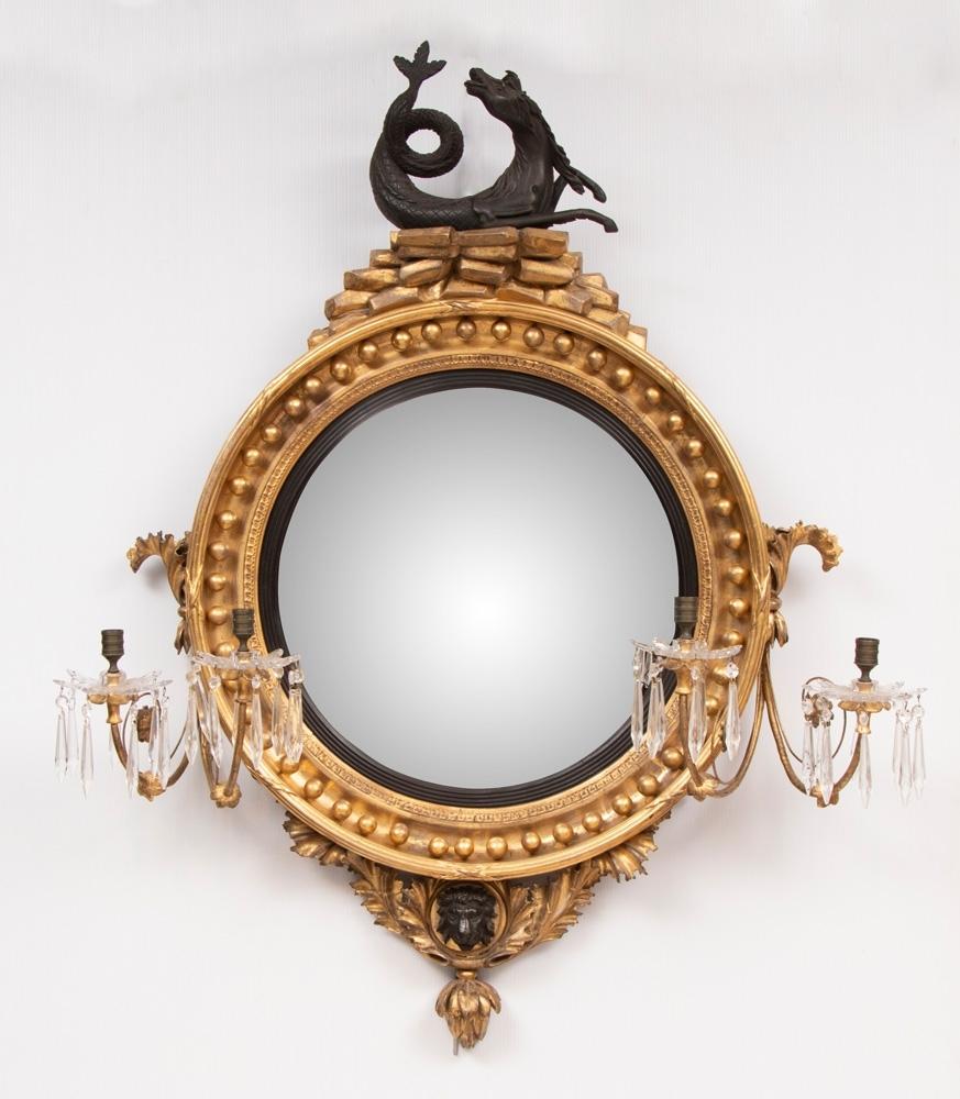 A very rare Regency convex mirror with a mounted Hippocamp in a truly superb hand-carved gilded original wood frame. This is an extraordinary, beautiful and rare piece of exquisite quality.
The original mercury backed convex period mirror plate is