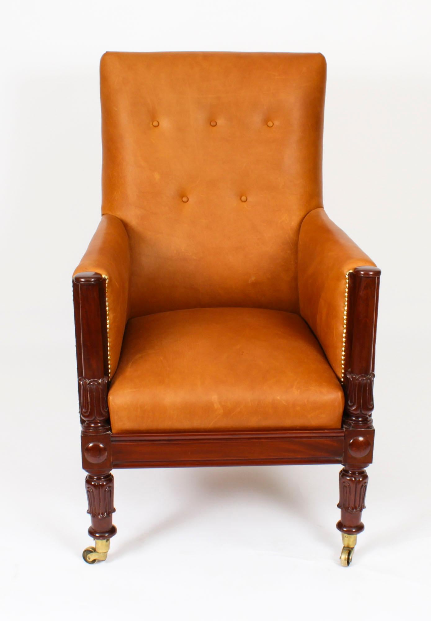 This is a very handsome  antique  Regency library armchair, circa 1830 in date.
This beautiful armchair is  made of solid mahogany and has been reupholstered in a sumptuous Italian tan leather by Moore & Gile. It features a buttoned back, raised