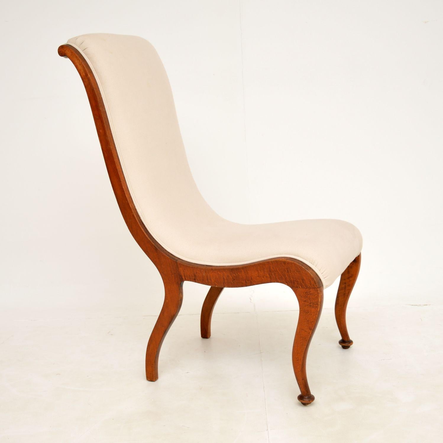 A beautiful and elegant Regency period easy chair in solid beech or walnut. This was made in England, it dates from around the 1820-1830 period.

This has a gorgeous shapely design, and is quite small yet very comfortable. The whole frame is