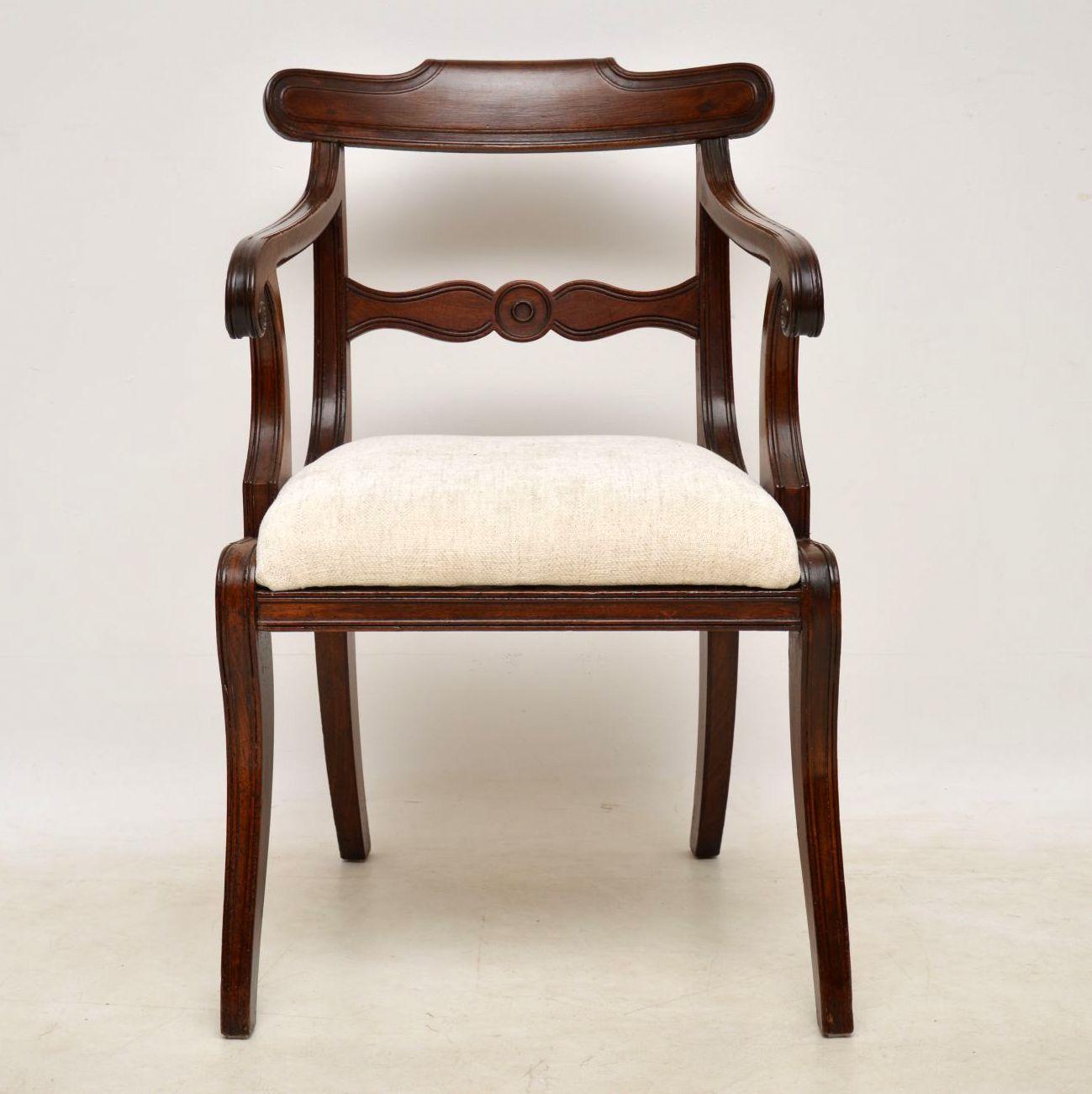 Antique Regency mahogany armchair dating from the 1820s period and in good condition. It’s recently been polished and the drop in seat has been re-upholstered. This chair has a curved back, scroll over arms and front sabre legs. I find these chairs
