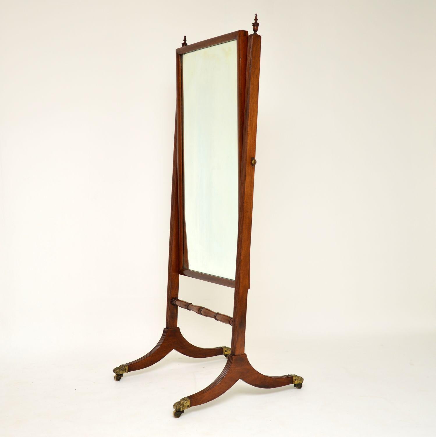 Very smart antique Regency mahogany cheval mirror in very good original condition and dating from circa 1810s-1820s period. It has reeded sides and legs, with original brass paw casters. The swing mirror can be adjusted and tighten with brass