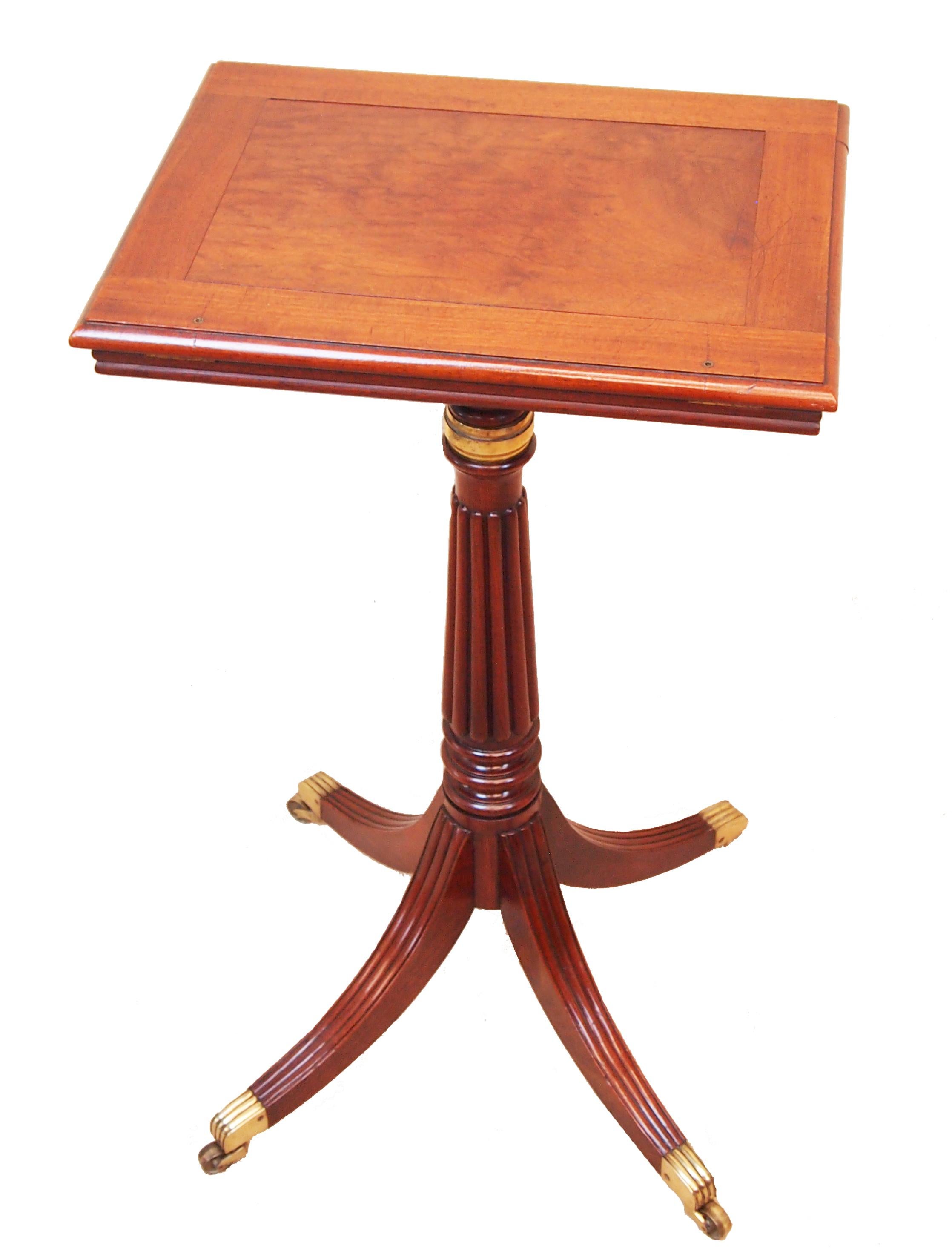 An exceptional quality Regency period Mahogany music stand,
or reading table, having superbly figured ratcheted adjustable 
top raised on elegant reeded column and four splayed legs
with original brass cup castors.